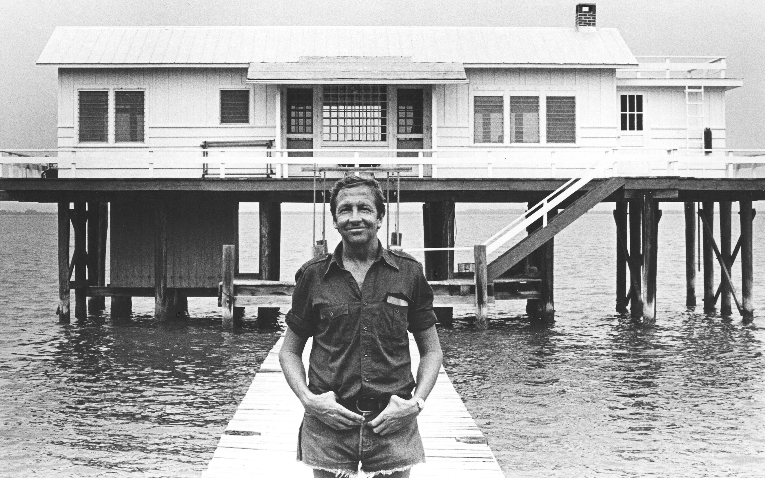 Photograph of Robert Rauschenberg in front of Fish House, Captiva, Florida, 1979