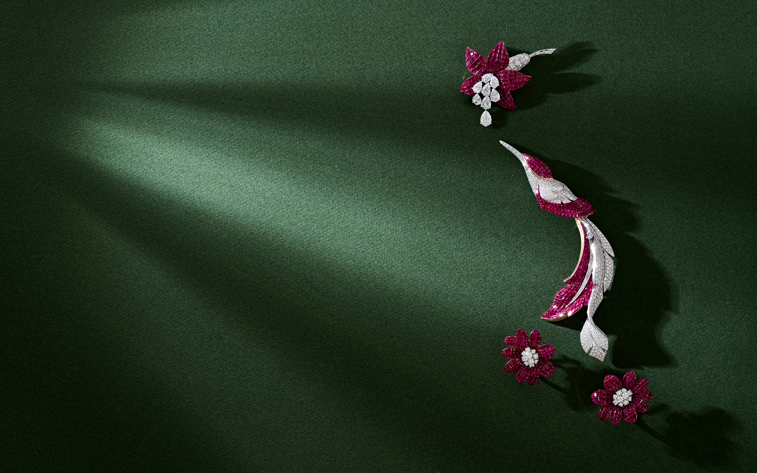Mystery-set jewels by Van Cleef and Arpels, from top: a ruby and diamond 'Fuschia' clip-brooch; a ruby and diamond 'Oiseau Mysterieux' brooch; and a pair of ruby and diamond 'Cadix' earrings. All offered in Exceptional Jewels and Objects of Elegance: A Connoisseur's Collection - part I on 10 November 2026 at Christie's in Geneva