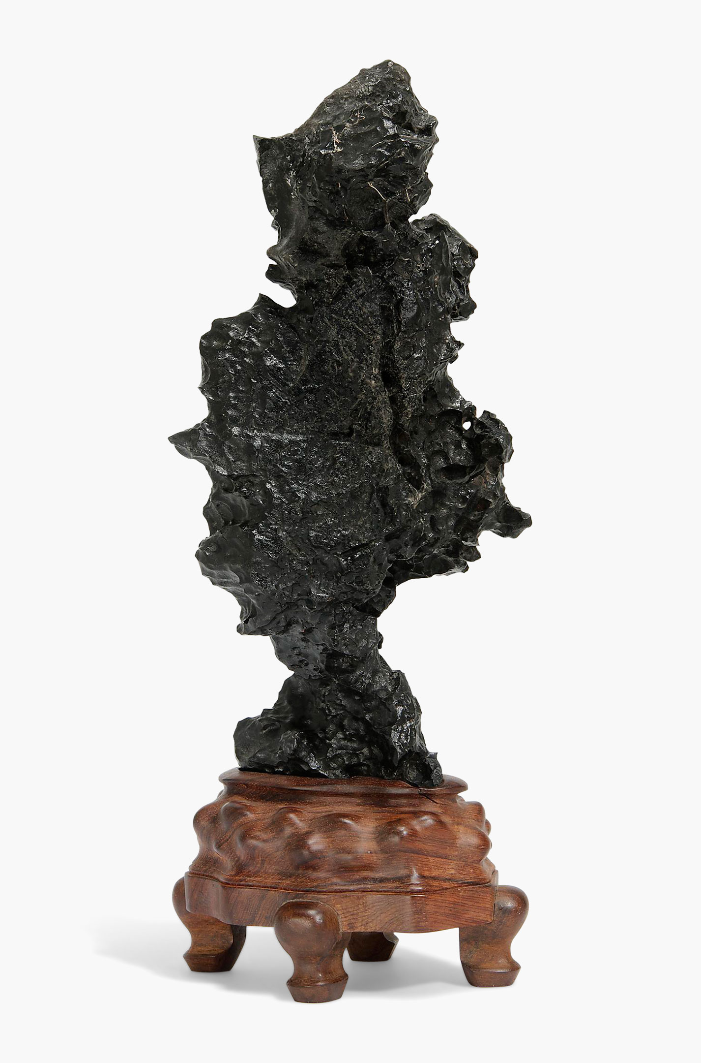 A black stone scholar’s rock. China, Qing dynasty (1644–1911). 11 3/4 in. (30 cm.) high, carved wood stand. Estimate: $4,000–6,000. This work is offered in the Asian Art Inspired by Nature online auction on 19–28 April