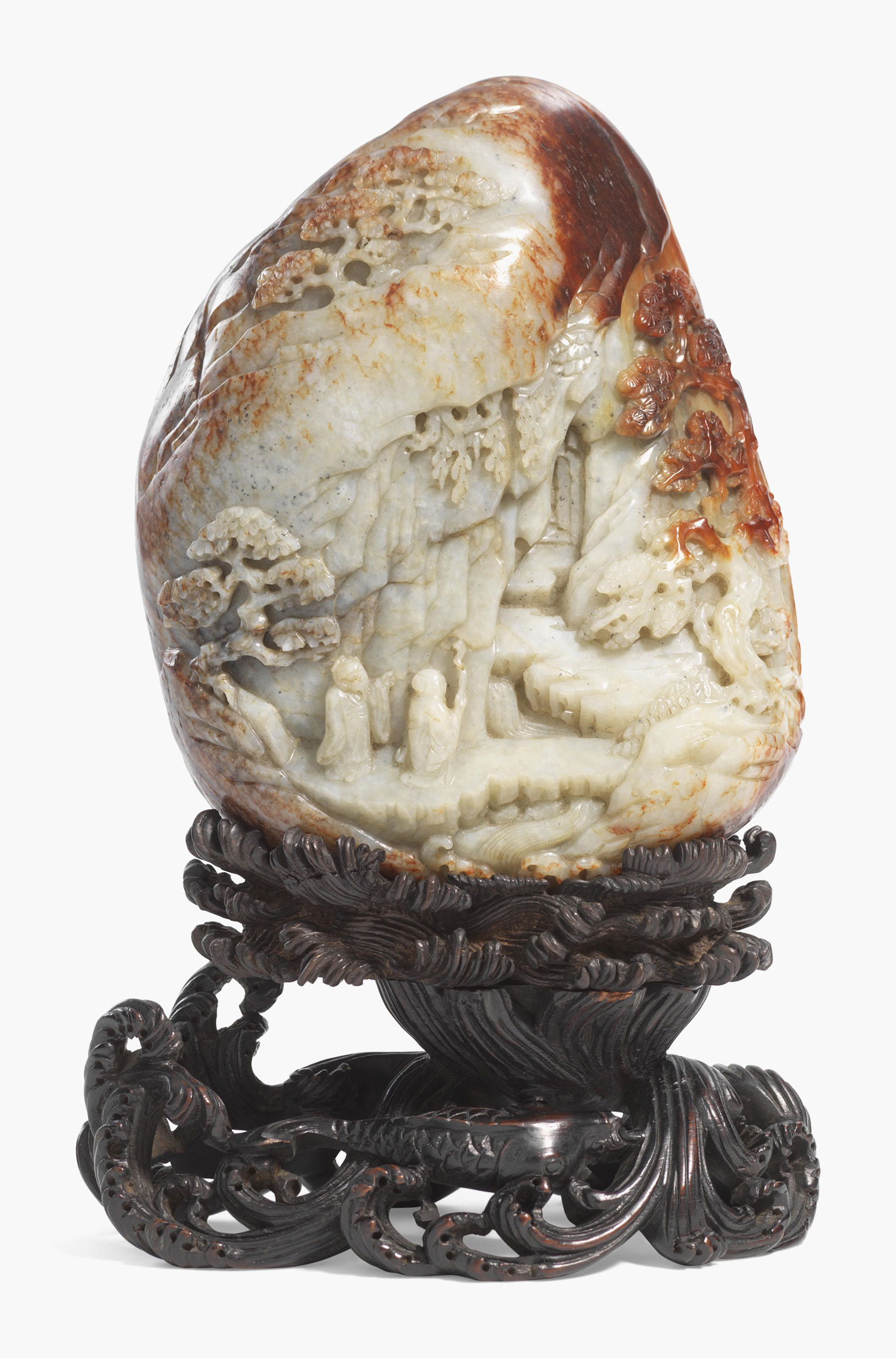 A finely carved pale celadon and russet jade boulder. China, 18th century. 6 1/4 in. (16 cm.) high, wood stand. Estimate: $30,000–40,000. This work is offered in the Asian Art Inspired by Nature online auction on 19–28 April