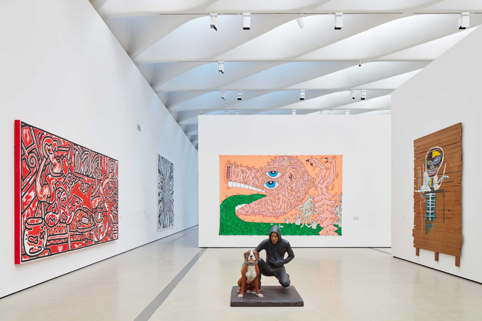In foreground: John Ahearn, Raymond and Toby, 1989; From left, Keith Haring, Red Room, 1988; Keith Haring, Untitled, 1984; Jean-Michel Basquiat, Gold Griot, 1984. © John Ahern. Keith Haring artworks © Keith Haring Foundation © The Estate of Jean-Michel Basquiat / ADAGP, Paris / ARS, New York 2016