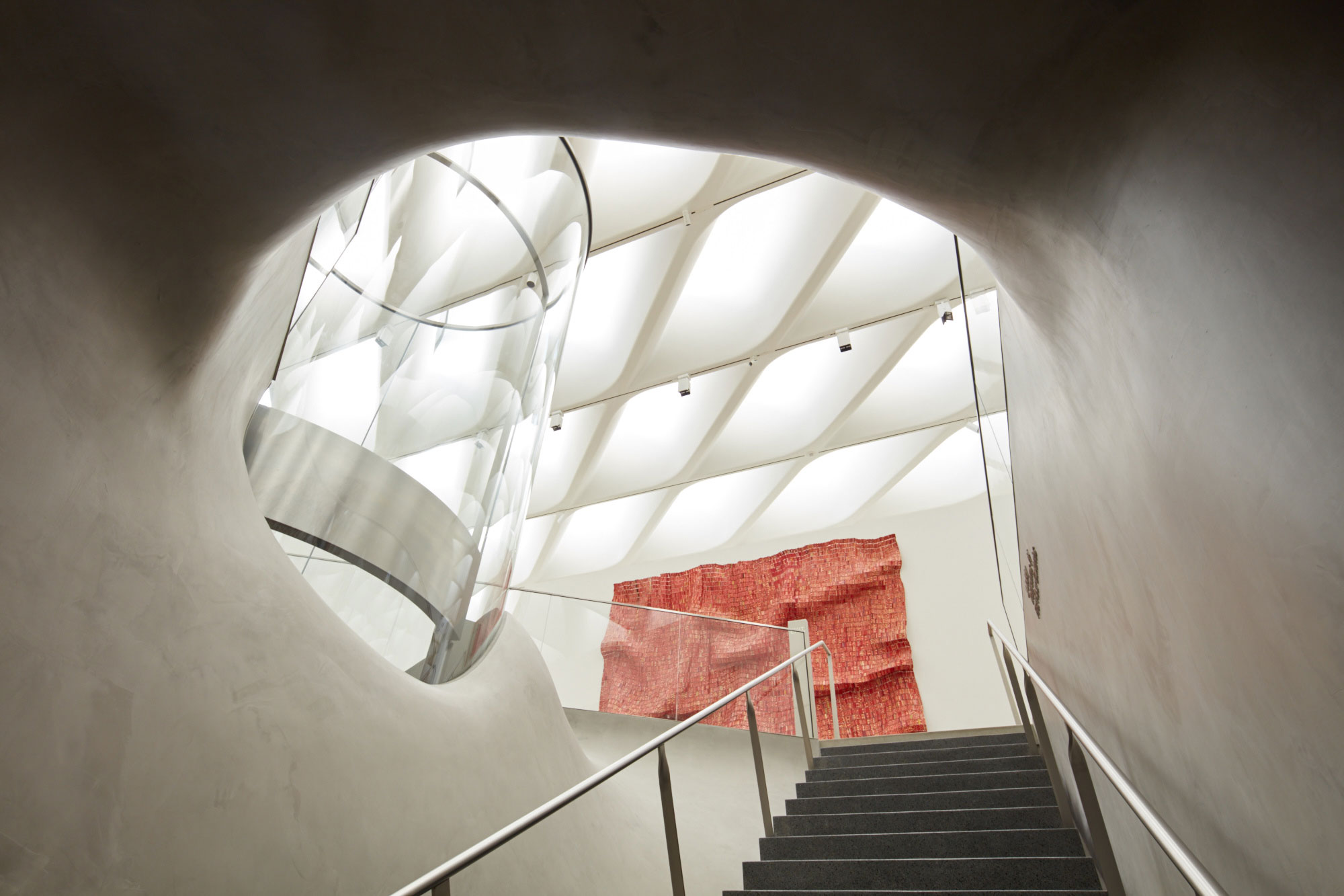 A stairway at The Broad, and El Anatsui, Red Block, 2010 © El Anatsui, courtesy of the artist and Jack Shainman Gallery, NY
