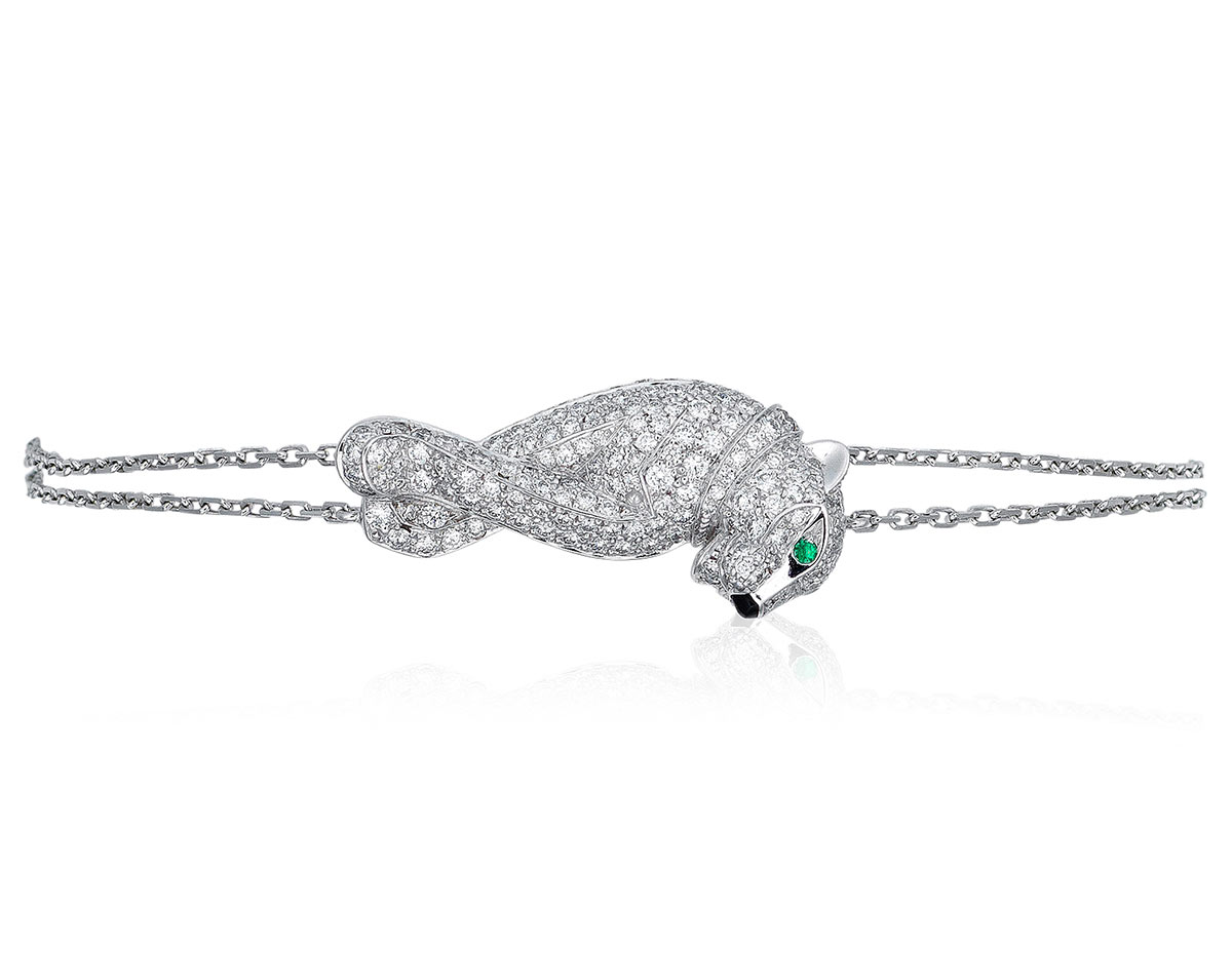 Cartier diamond and emerald 'Panthère' bracelet. Designed as a diamond set panther with emerald eyes and black lacquer nose on white gold chain. Estimate: $15,000–25,000 HKD