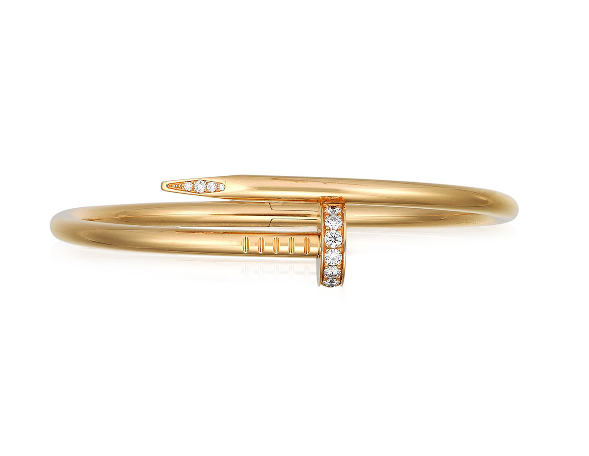 Cartier diamond 'Juste un clou' bangle. Designed as a bypass nail bangle accented with round diamonds. Estimate: HKD $15,000–25,000