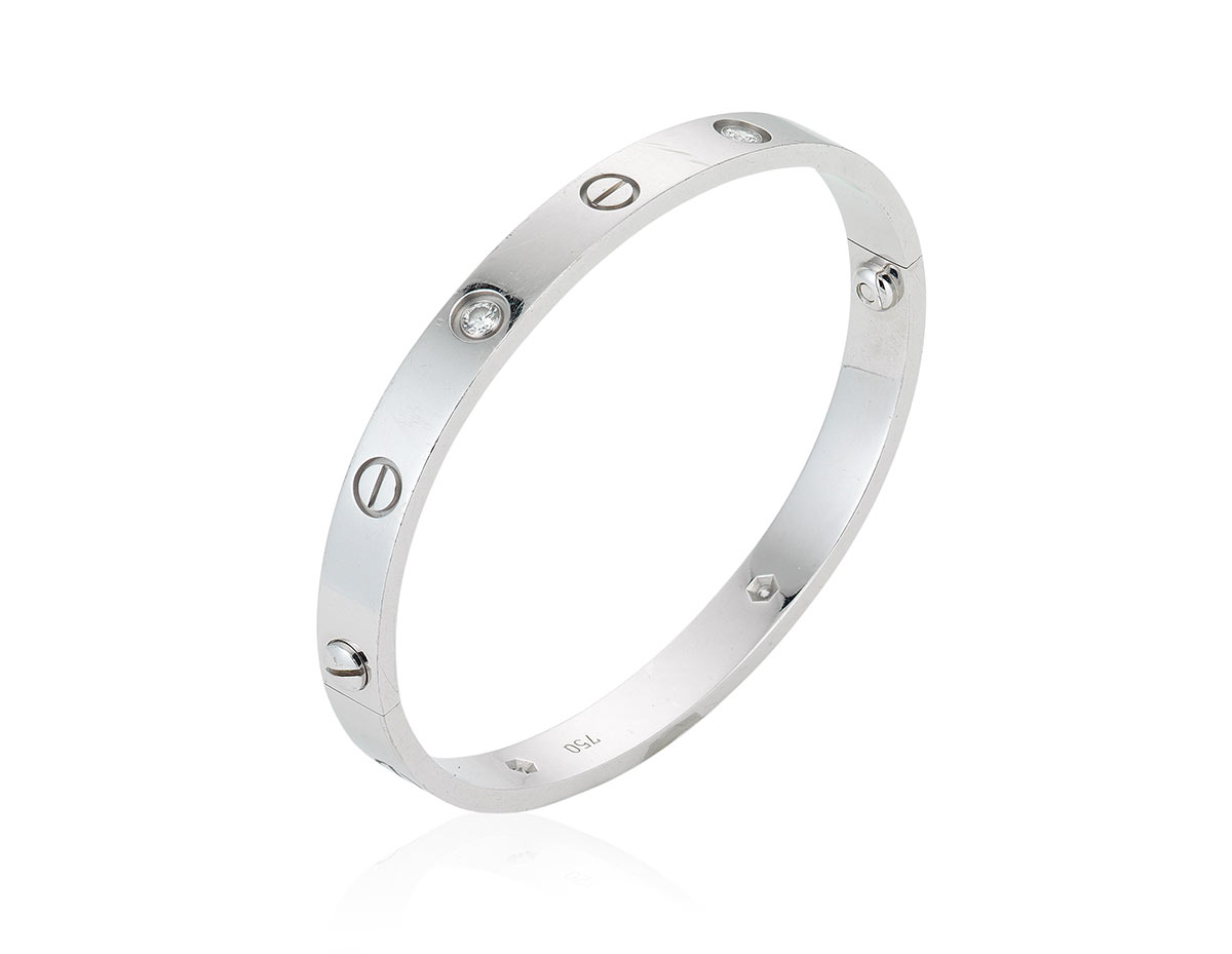 Cartier diamond 'Love' bangle. Set with four round diamonds alternating with screw motifs, accompanied by a screwdriver. Estimate: HKD $15,000 – 25,000