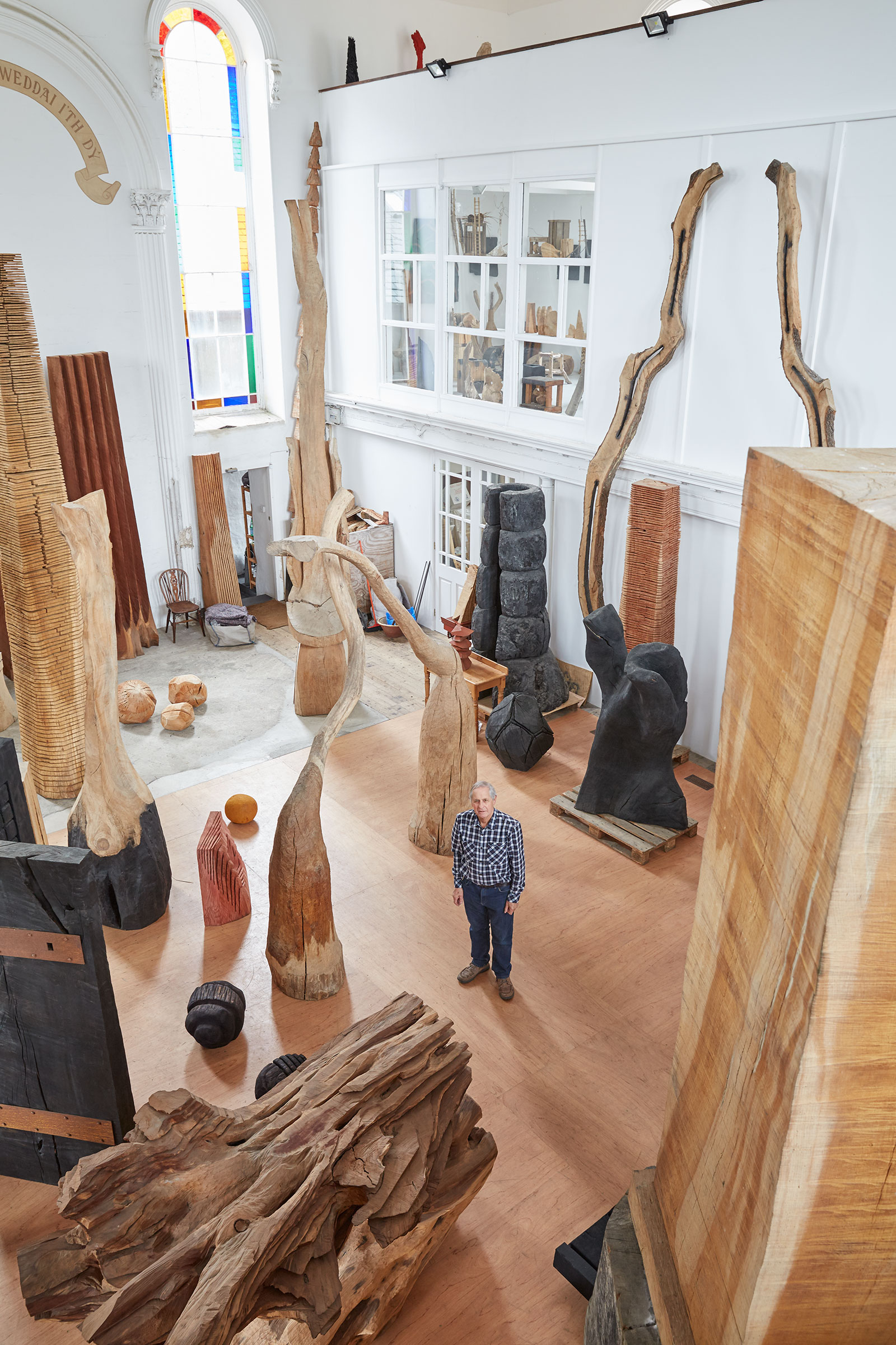 The artist pictured with some of his wooden sculptures. Photograph by Robin Friend