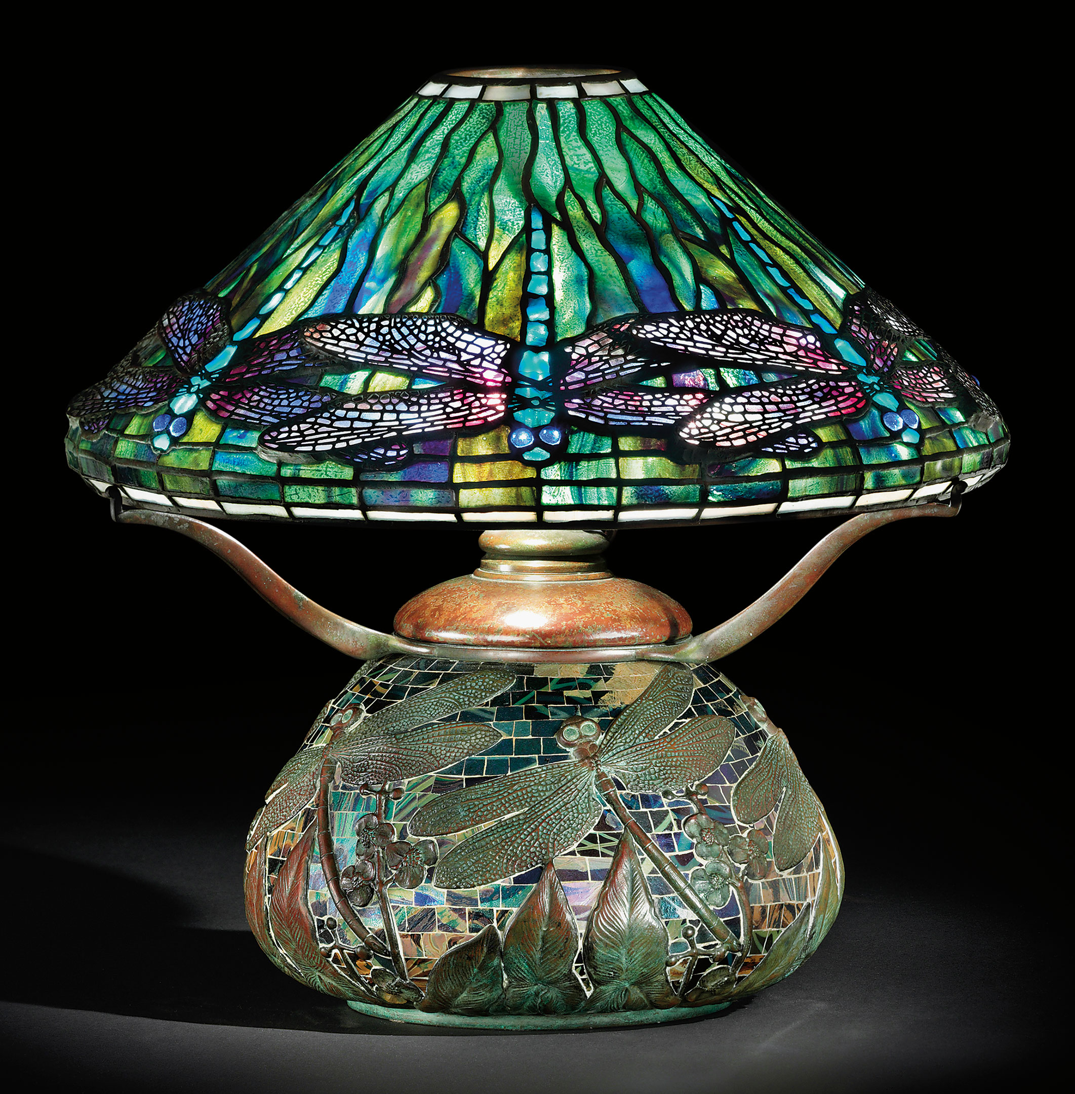 Tiffany Studios, A 'dragonfly' leaded glass, bronze and mosaic table lamp, circa 1905. 17¼ in (43.6 cm) high, 16½ in (41.8 cm) diameter of shade. Sold for $602,500 on 8 December 2009