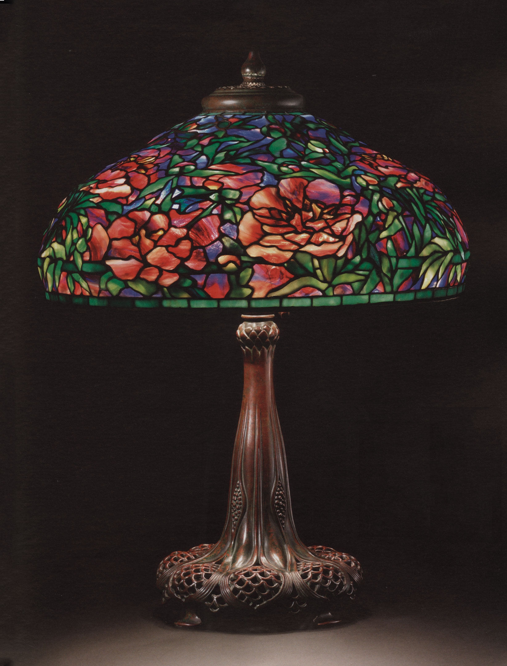 Tiffany Studios, An elaborate ‘Peony’ leaded glass and bronze table lamp, circa 1915. 29½ in (75 cm) high, 22¼ in (56.4 cm) diameter of shade. Sold for $1,538,500 on 8 December 2009