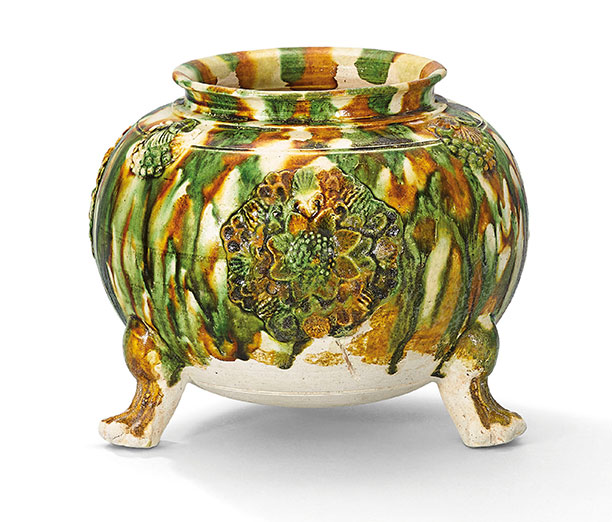 A sancai-glazed applique-decorated tripod jar. Tang dynasty (618-907). 5¼ in (13.3 cm) high, box. This work was offered in The Pavilion Sale on 4 October 2016 at Christie’s Hong Kong and sold for HK$275,000/$US35,600