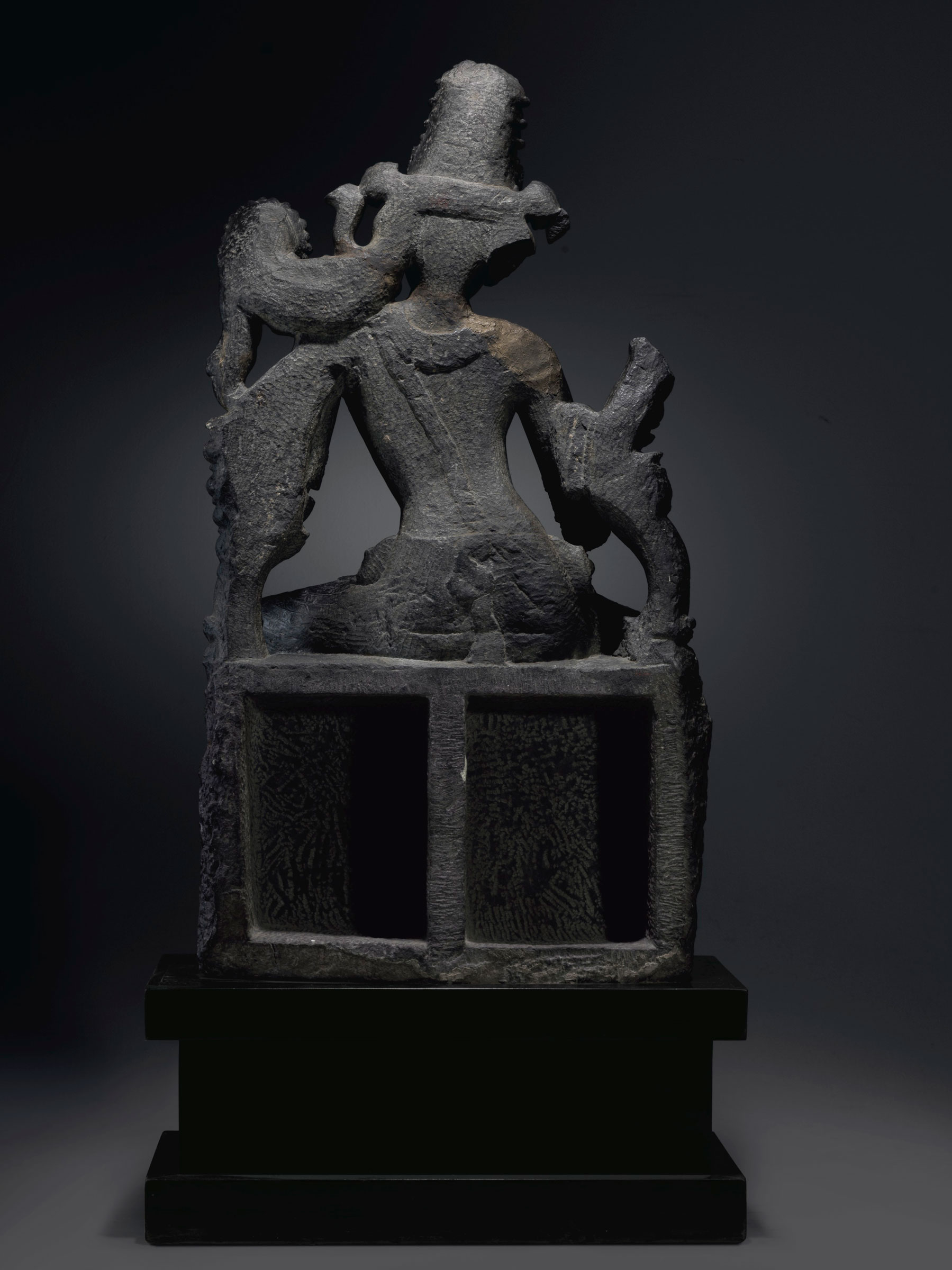The back of the figure has been carved in deep relief, and the lotus throne that forms the work&rsquo;s base has been hollowed out &mdash; a feature which, Coyle suggests, could have been intended to lighten the work