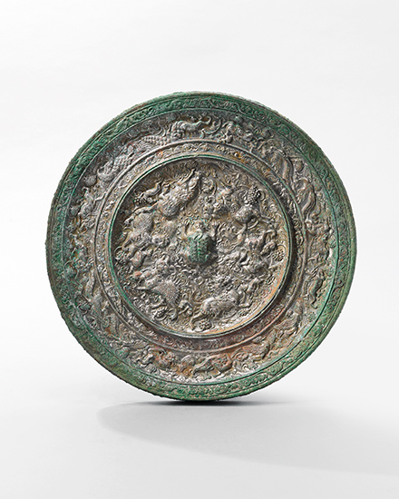 A very rare large &lsquo;Mythical Animals and Grapes&rsquo; bronze mirror Tang dynasty (618-907). 10&frac12; in (26.8 cm) diameter. Estimate: HK$3,660,000 on 4 April 2017 at Christie&rsquo;s in Hong Kong
