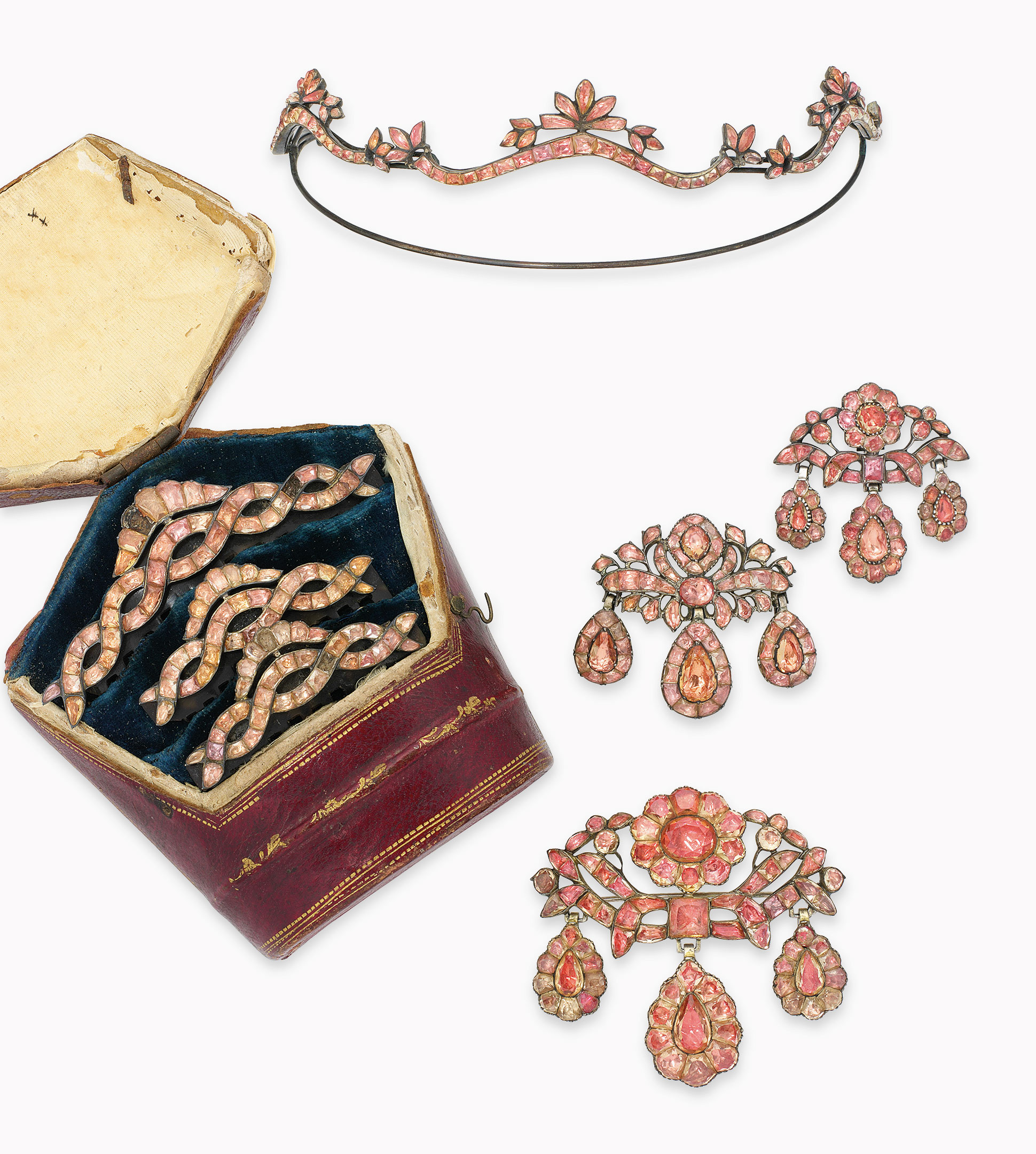 A group of late-18th-century Portuguese topaz jewellery. Comprising a bodice ornament and ear pendants of girandole design, a tiara, three hair combs and a crescent-shaped hair pin (not illustrated), each modelled as a scrolling ribbon with floral and foliate motifs entirely set with vari-cut topaz, foil-backed in silver, circa 1770. Estimate: £15,000-20,000. This lot is offered in Important Jewels on 13 June at Christie’s London