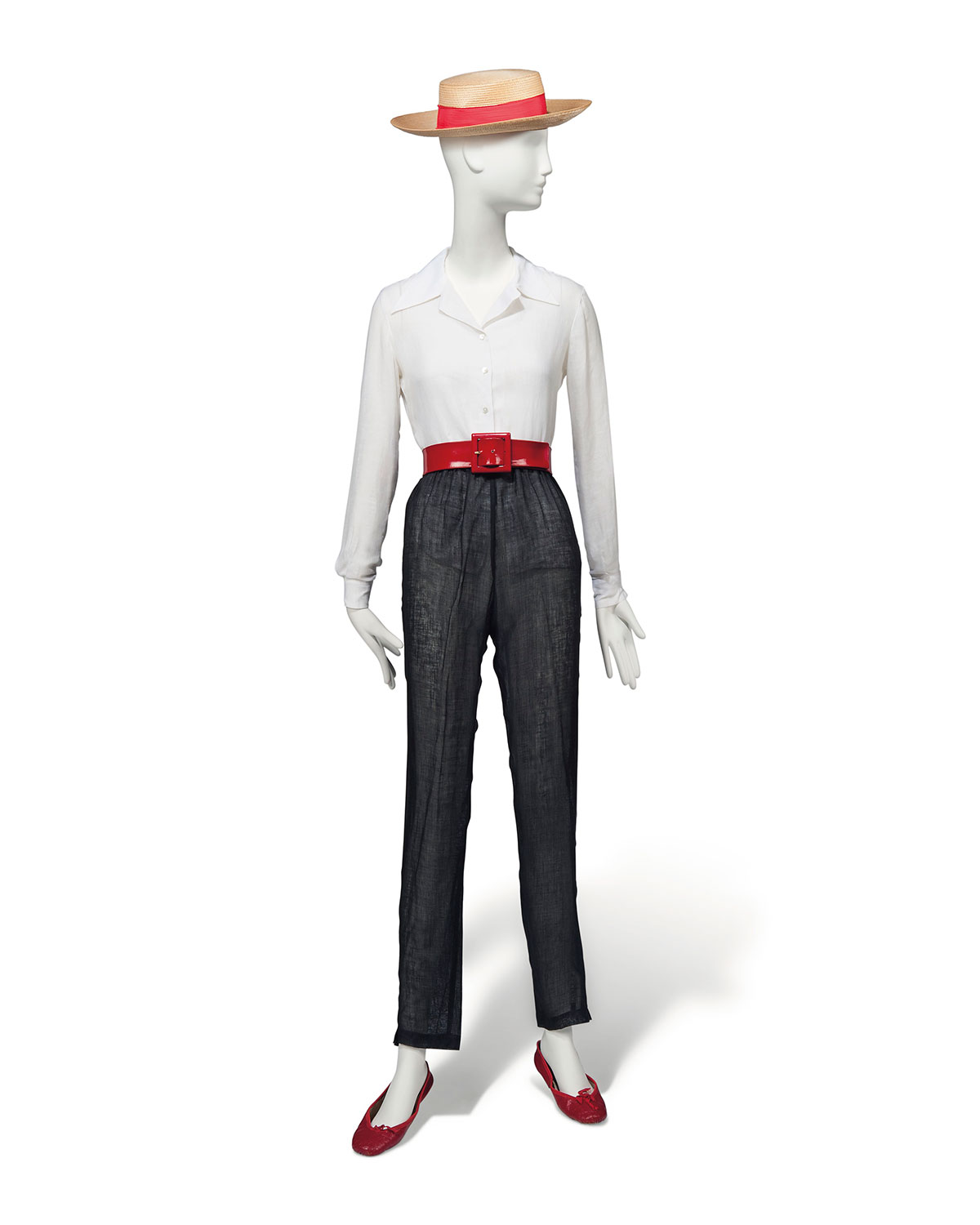 A crisp white linen shirt and black linen trousers, Basile and marisa padouan, 1980s, the open necked shirt with long sleeves, the trousers loosely cut, tapering to the ankle; together with gondolier's hat, red ballet pumps, possibly by capezio and a lipstick red belt; the hat with paper label il cappello di paglia, 0614, Yenezia, 31 Agosto 1983, with a red silk hat band. Estimate: £3,000-5,000. This lot is offered in Audrey Hepburn: The Personal Collection on 27 September 2017  at Christie’s in London