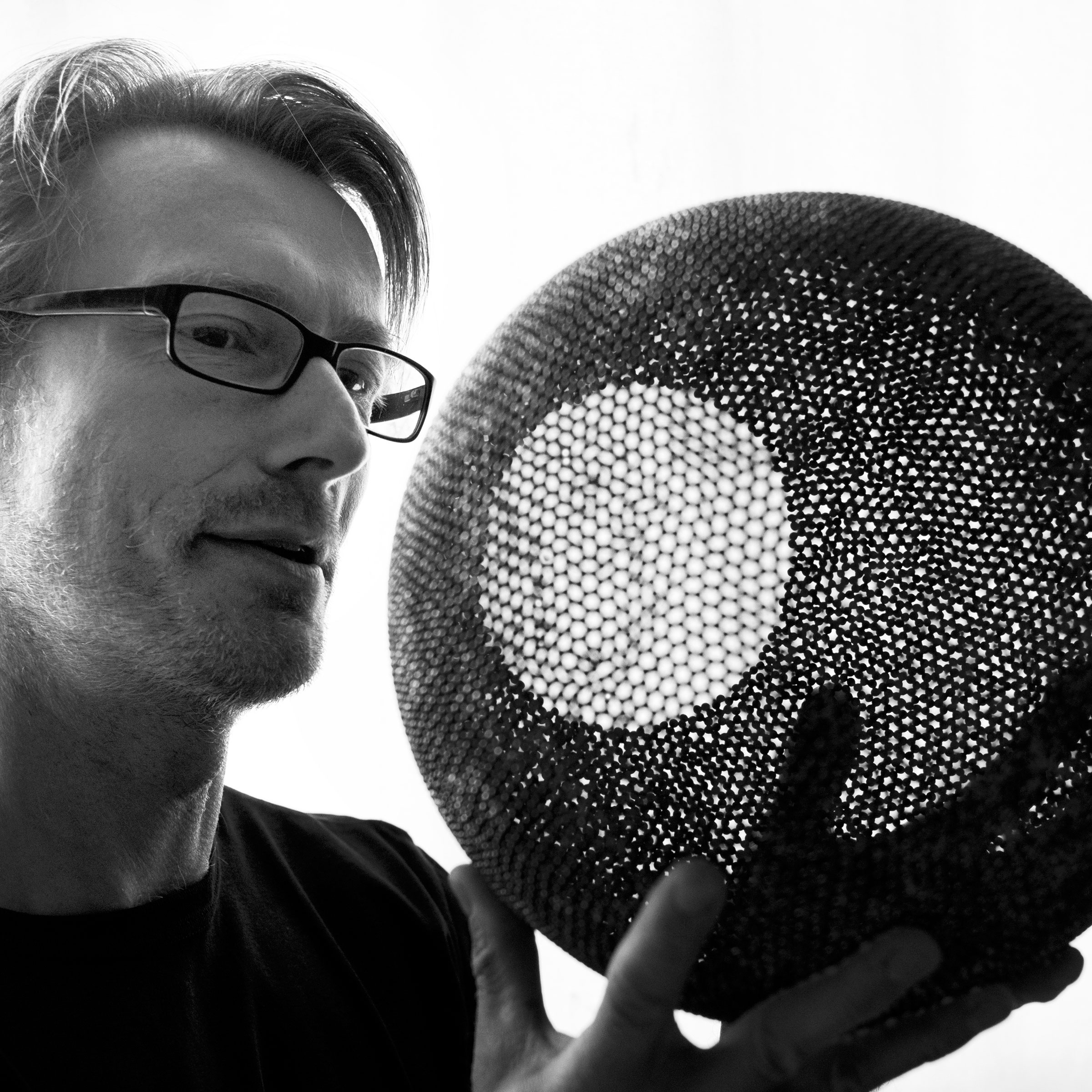 David Huycke with one of his artworks, Pearl Globe, 2012, created from thousands of silver granules. Photo: Claudia Hoppe