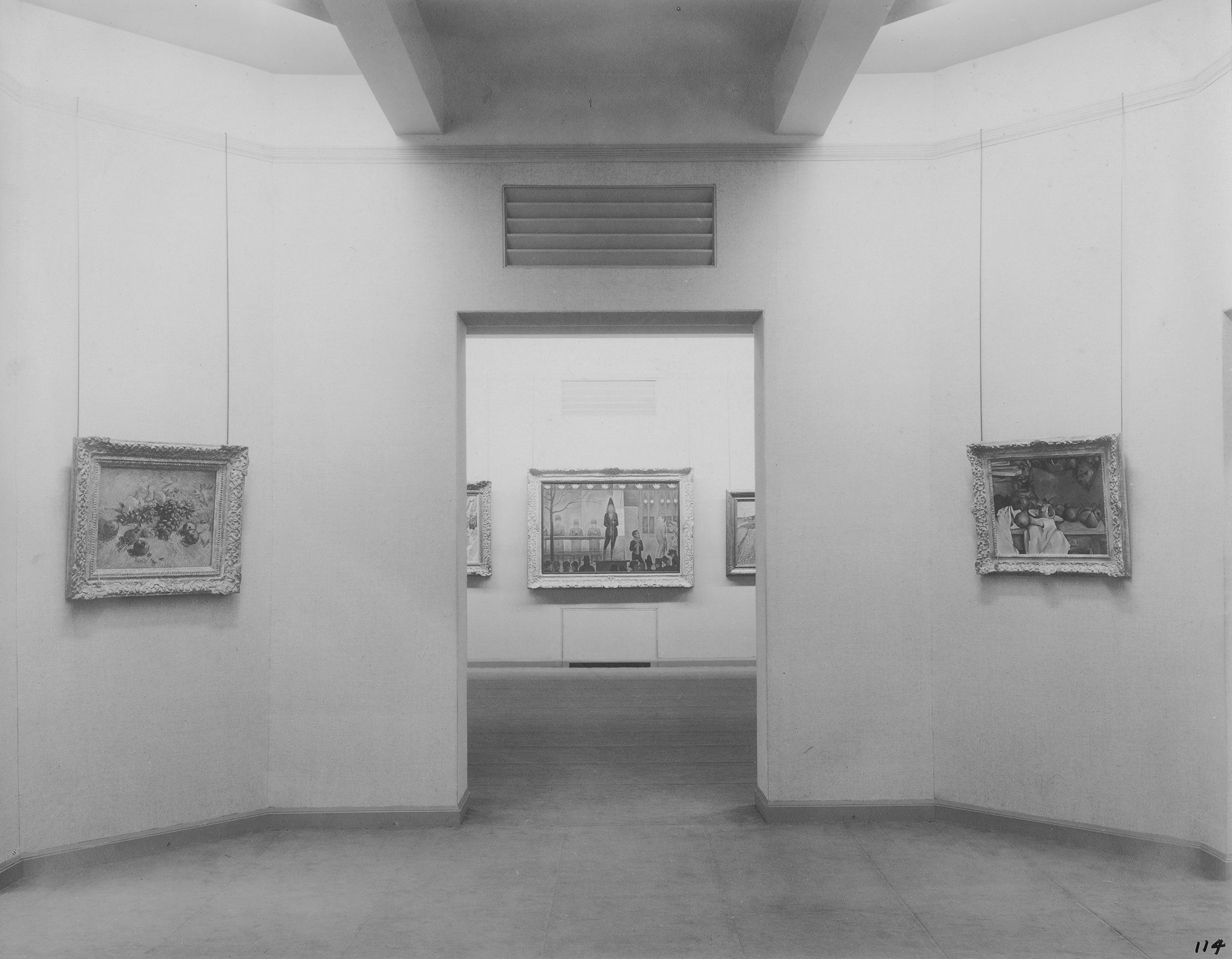 Installation view of the first exhibition at MoMA, Cézanne, Gauguin, Seurat, Van Gogh (7 November to 7 December, 1929). From left: Vincent van Gogh, Grapes, Lemons, Pears and Apples; (on back wall) Georges Seurat, Circus Sideshow (Parade de Cirque); Paul Cezanne, Ginger Pot with Pomegranate and Pears. Photo: © 2018, The Museum of Modern Art, New York/Scala, Florence. Photographer: Peter Juley.