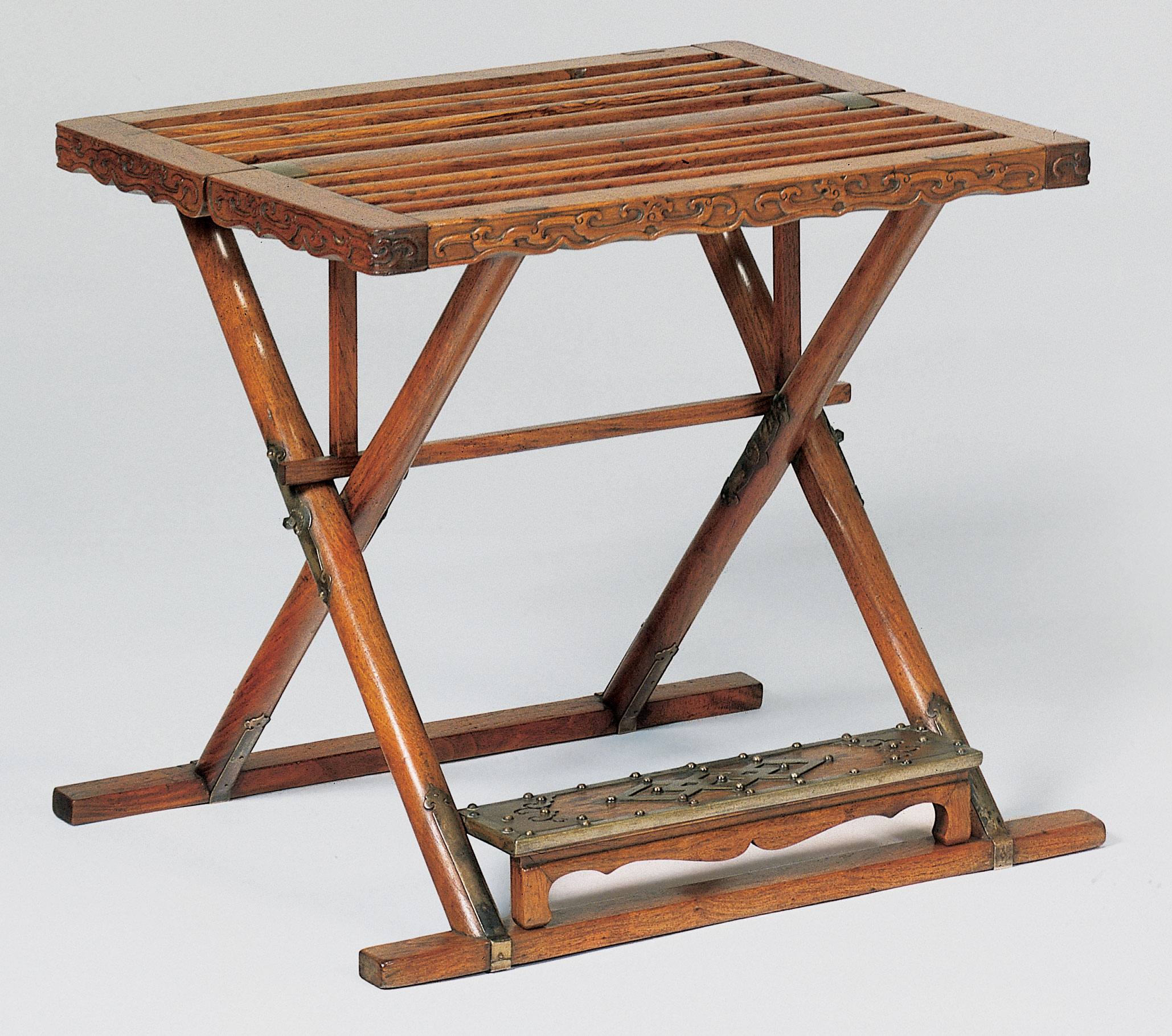 A rare and important pair of huanghuali folding stools, jiaoyi, late 17th- early 18th century. Sold for $321,500 on 18 September 1997 at Christie's in New York
