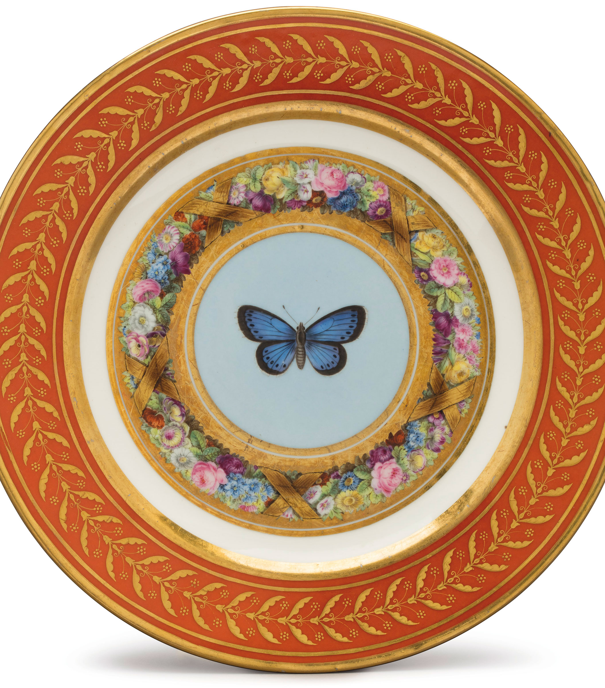 A plate with the service&rsquo;s rich, red borders, gilt with berry leaves