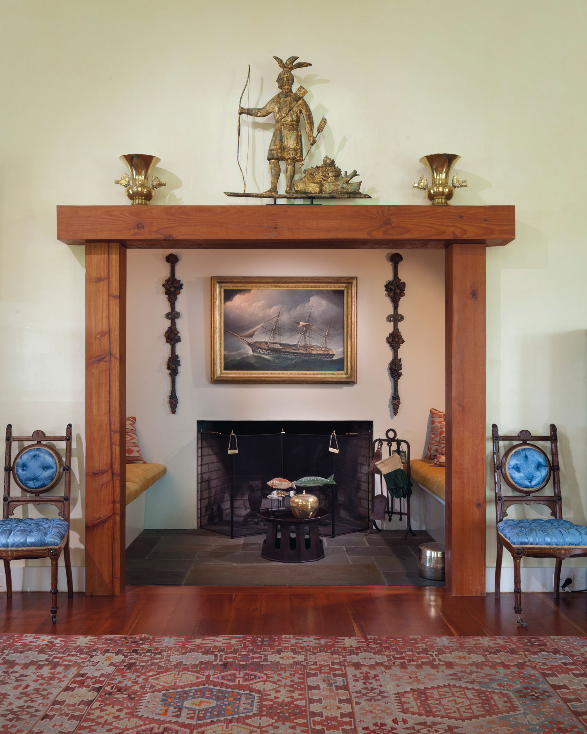 A molded and gilt-copper Massasoit Indian weathervane displayed on the mantel at Four Winds in Columbia County, New York