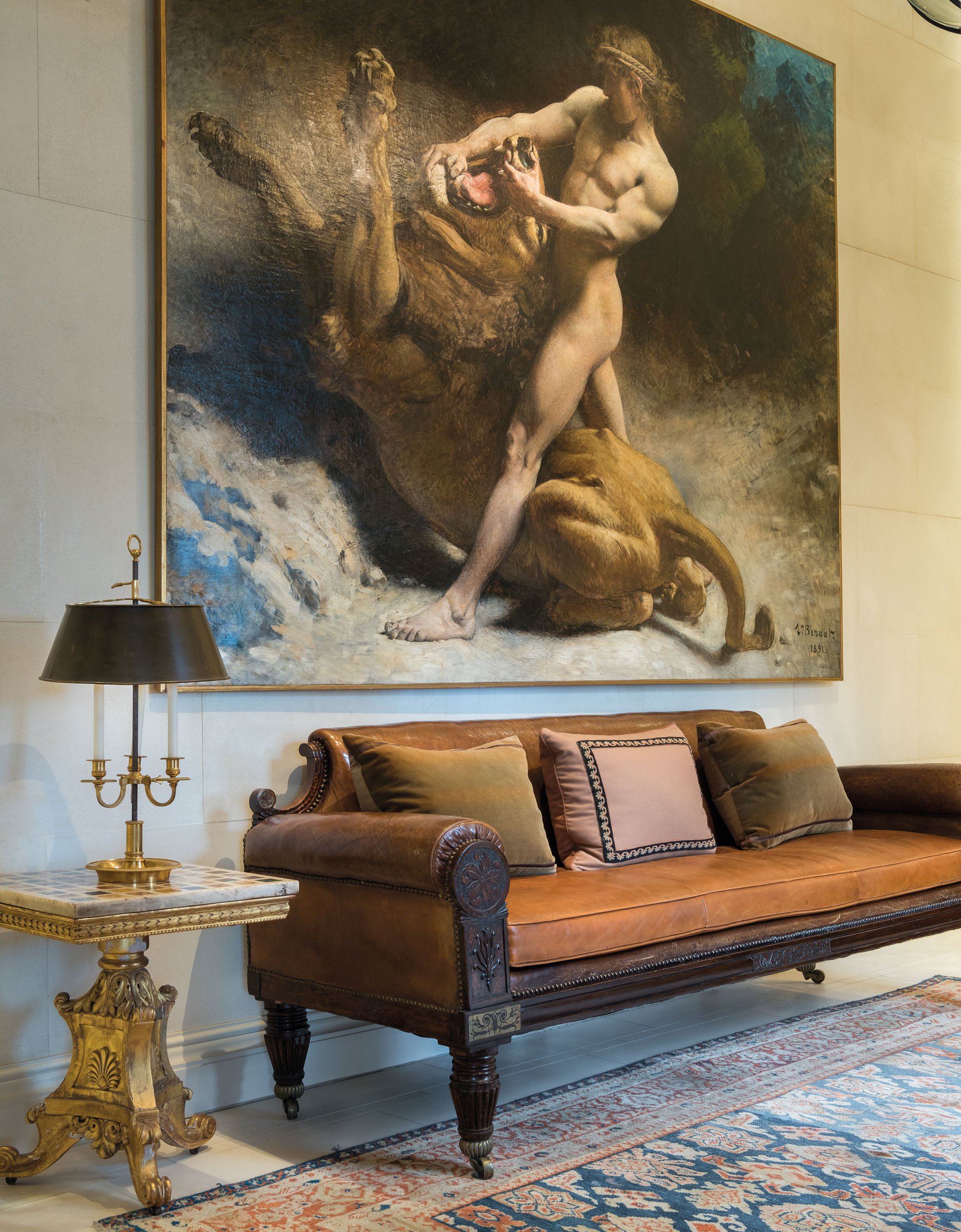 The hallway at the Eaton Square residence, with a painting by Léon Joseph Bonnat, Samson’s Youth (Estimate: £250,000-350,000) and a George IV sofa (£3,000-5,000). The Directoire ormolu Bouillotte lamp (£4,000-6,000) sits on an Italian marble specimen table top on a William IV base (£3,000-5,000). Offered in Rooms as Portraits: Michael S. Smith, Eaton Square, London on 12 September