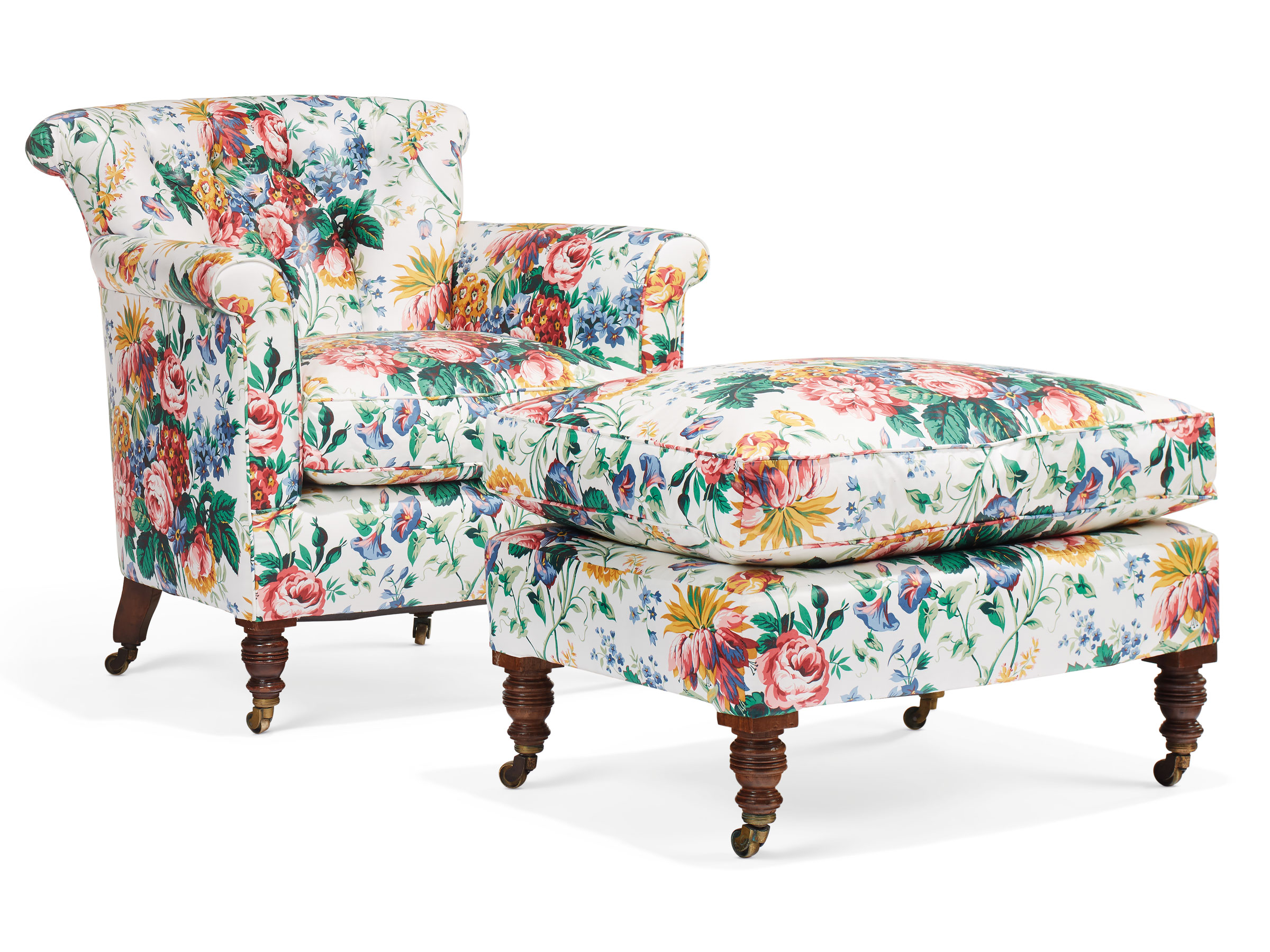 The same chair and ottoman, reupholstered with a traditional chintz fabric. A late victorian stained beechwood club chair and ottoman, by Howard &amp; Sons, late 19th century, with ringturned baluster tapering legs and brass caps and castors and stamped 12666/9009 Howard and Sons Berners St. Estimate: $1,000-1,500. Offered in Little Cassiobury: The Collection of Susan Lyall on 16 January 2019 at Christie&rsquo;s in New York