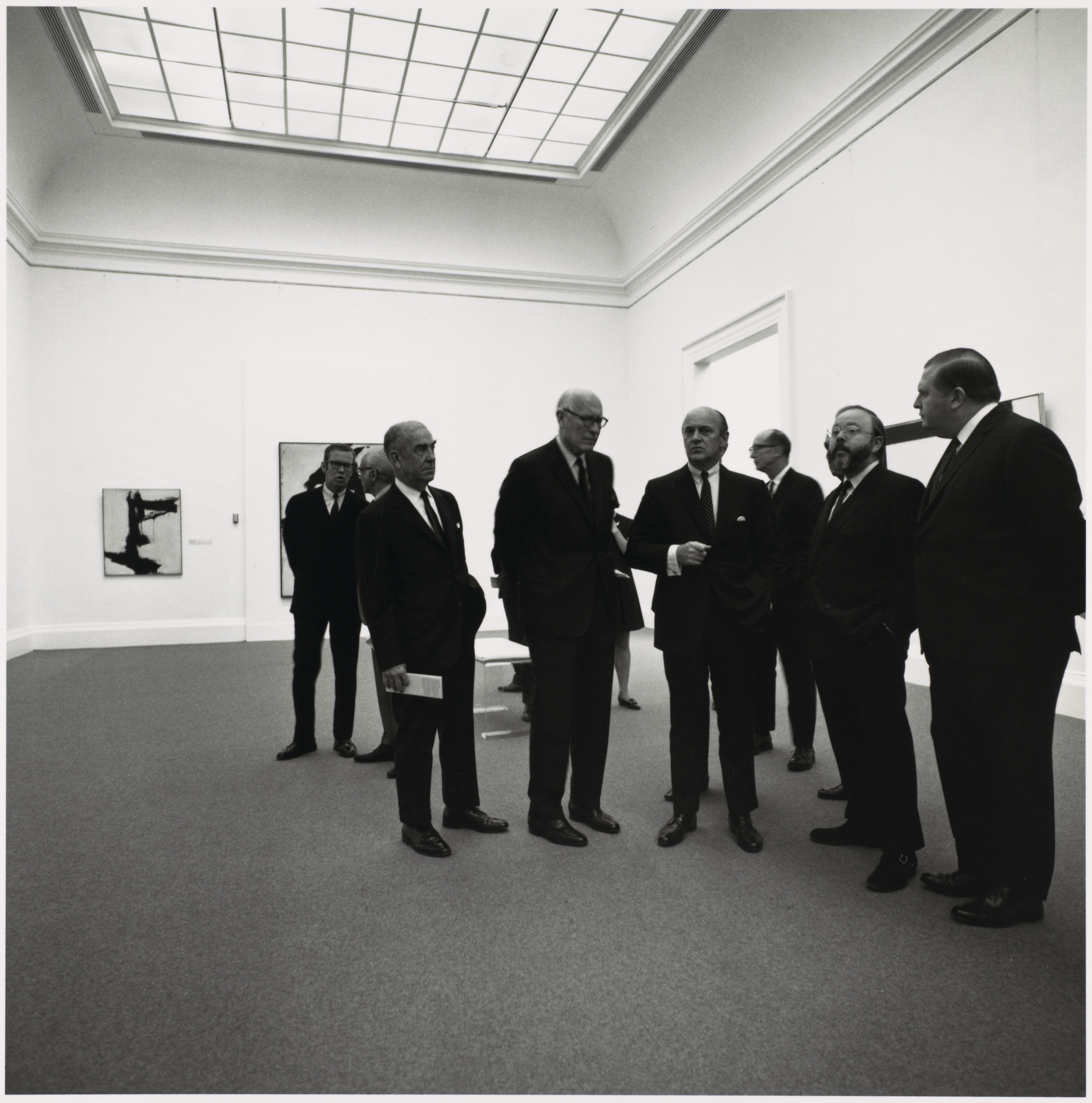 Henry Geldzahler (second right) shows visitors around New York Sculpture & Painting: 1940-1970, the landmark exhibition he curated at the Metropolitan Museum in 1969. Photograph: © Bruce Davidson / Magnum Photos. Image © 2019 The Metropolitan Museum of Art/Art Resource/Scala, Florence. Artwork: © Franz Kline, DACS 2019