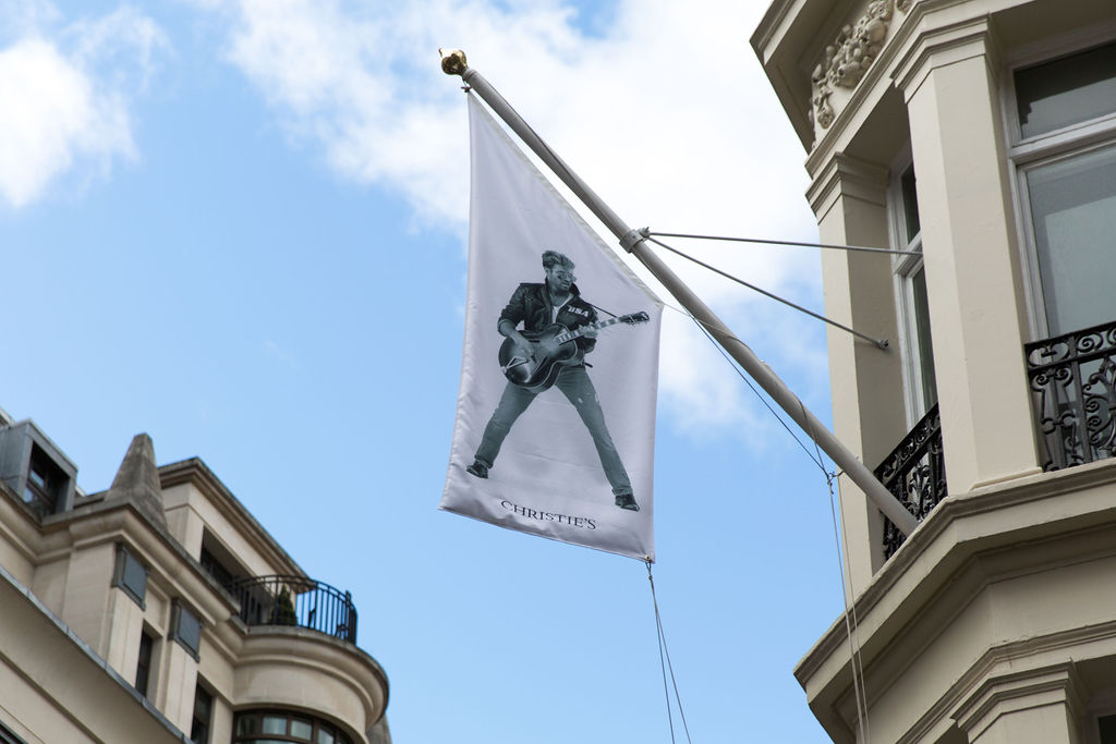 Flags showing the star during the period he released the multi-platinum album Faith flutter on all four corners of Christie’s King Street headquarters