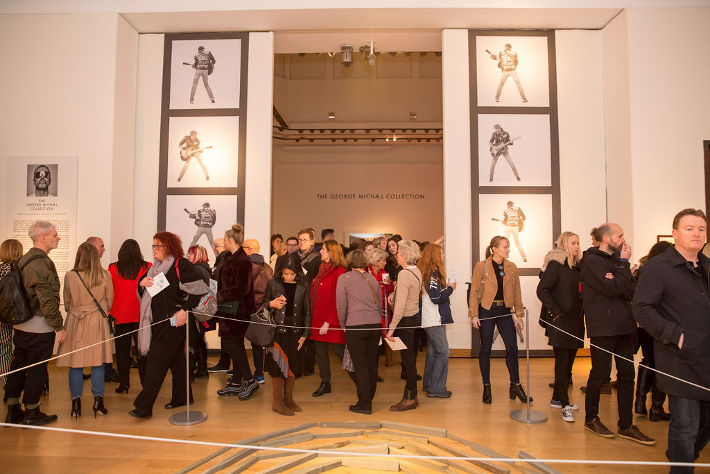 Crowds explore the King Street galleries, this one containing  Green Slate Spiral  by Richard Long