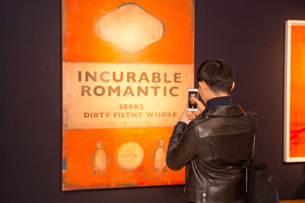 A visitor admires Harland Miller’s Incurable Romantic Seeks Dirty Filthy Whore, executed in 2007, the same year it was acquired by George Michael