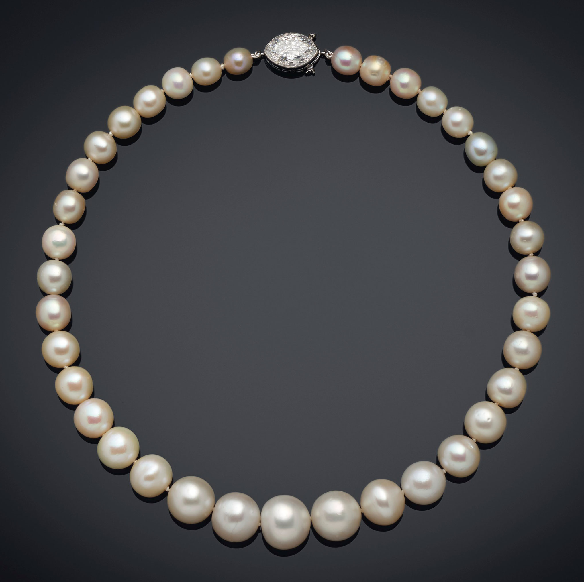 A natural pearl and diamond necklace, Cartier. 37 round to oval natural pearls of 14.00 to 7.05 mm, old-cut marquise-shaped diamond, platinum (French marks), 15¼  in. Estimate: $1,000,000-1,500,000. Offered in Maharajas & Mughal Magnificence on 19 June 2019 at Christie’s in New York