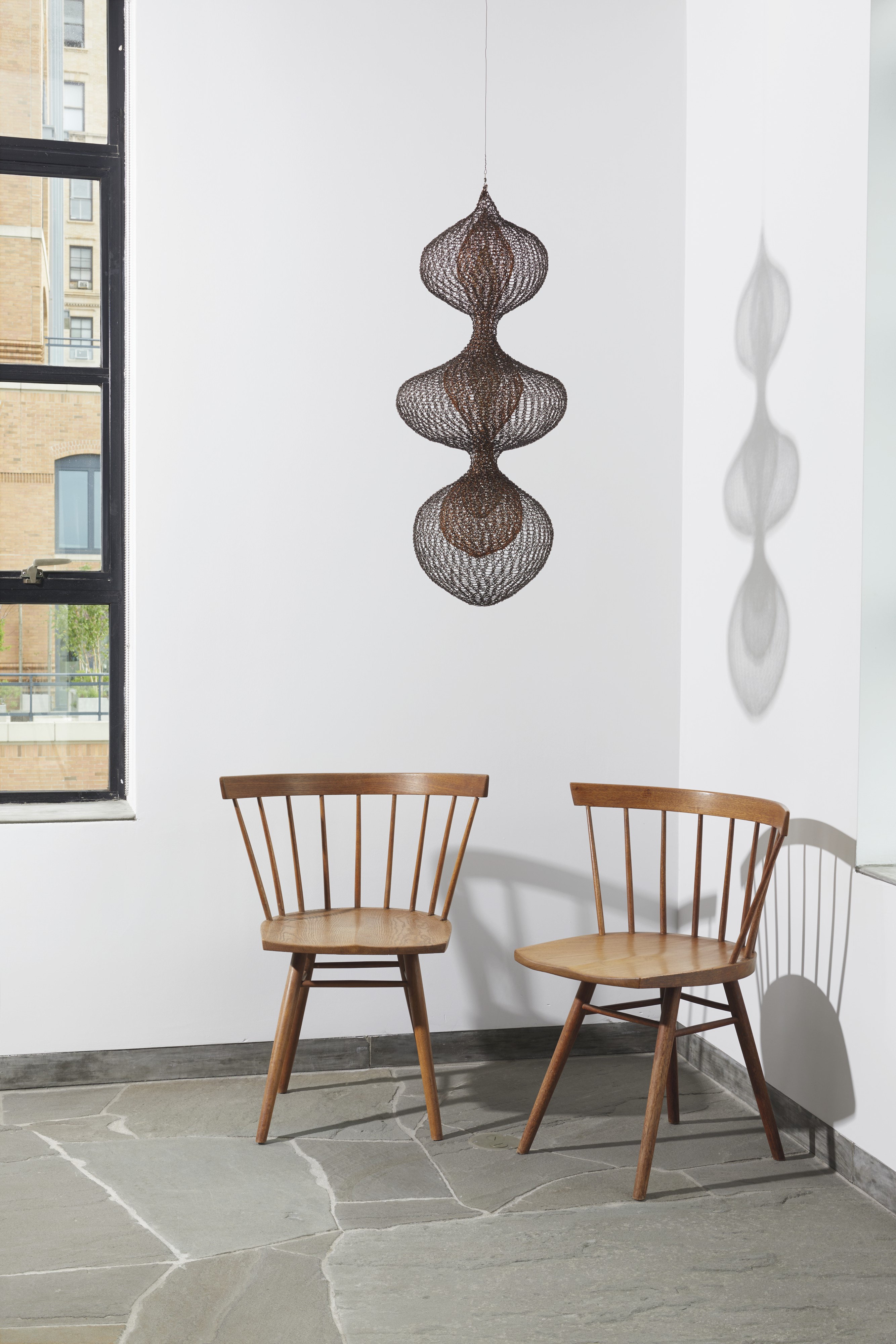 Alexander Kaplen&rsquo;s home. Artwork: George Nakashima (1905-1990), Two Early &lsquo;Straight&rsquo; Chairs, circa 1947. Walnut and oak. Each: 28&frac12; in (79.4 cm) high; 24⅜ in (61.9) cm wide; 18&frac14; in (46.4 cm) deep. Estimate: $3,000-5,000.&nbsp;Offered in Design&nbsp;on 13 December at Christie&rsquo;s in New York. Ruth Asawa (1926-2013),&nbsp;Untitled S.387 (Three Lobed Continuous Form with Two Interior Lobed Continuous Forms)&nbsp;circa 1955. Hanging sculpture: copper, brass and gold wire. 34&frac12; x 15 x 15 in (87.6 x 38.1 x 38.1 cm) Sold for $4,095,000 on 14 November at Christie&rsquo;s in New York. &copy; Estate of Ruth Asawa