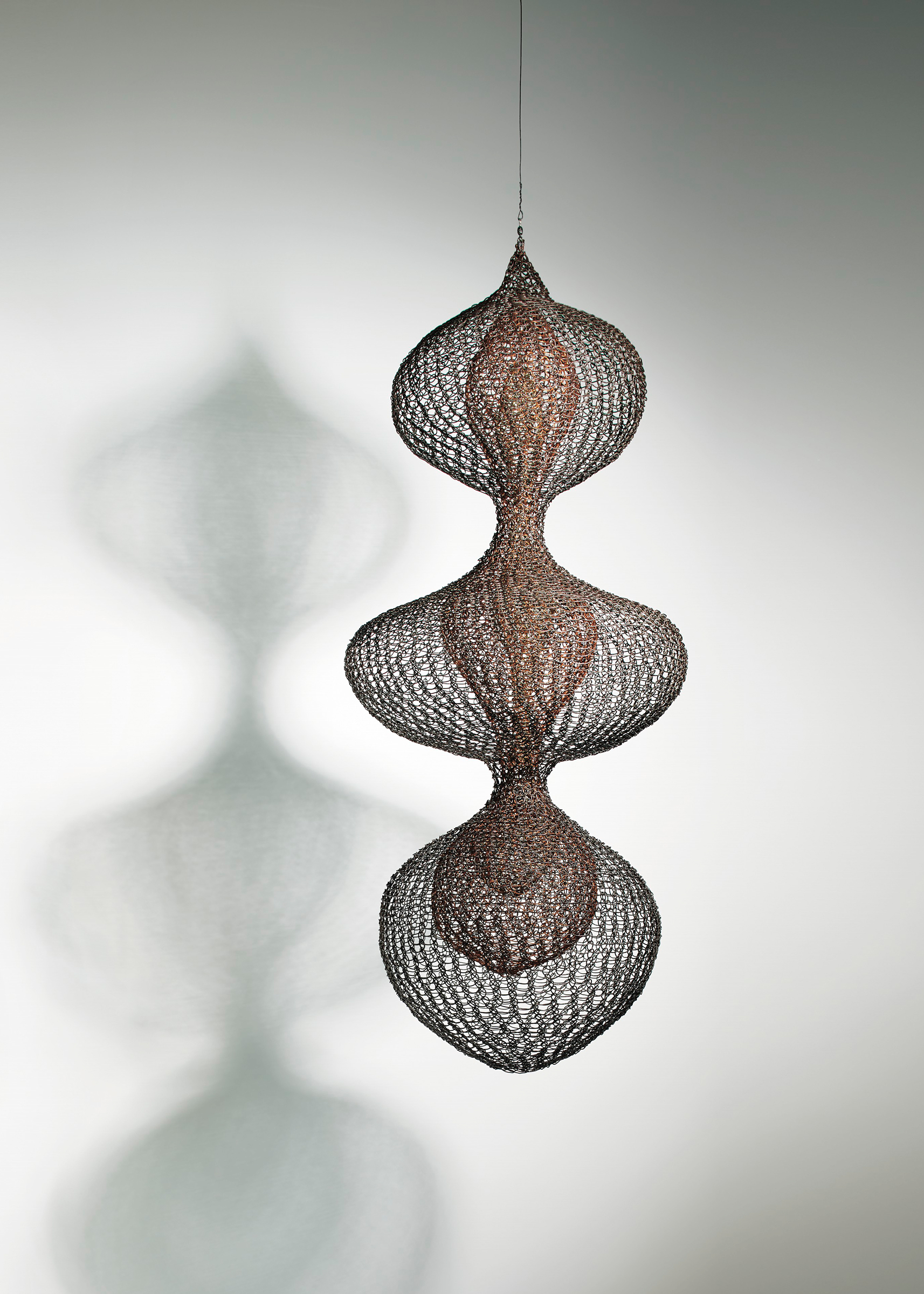 Ruth Asawa (1926-2013), Untitled S.387 (Three Lobed Continuous Form with Two Interior Lobed Continuous Forms)&nbsp;circa 1955. Hanging sculpture: copper, brass, and gold wire. 34&frac12; x 15 x 15 in (87.6 x 38.1 x 38.1 cm) Sold for&nbsp;$4,095,000 on 14 November at Christie&rsquo;s in New York. &copy; Estate of Ruth Asawa