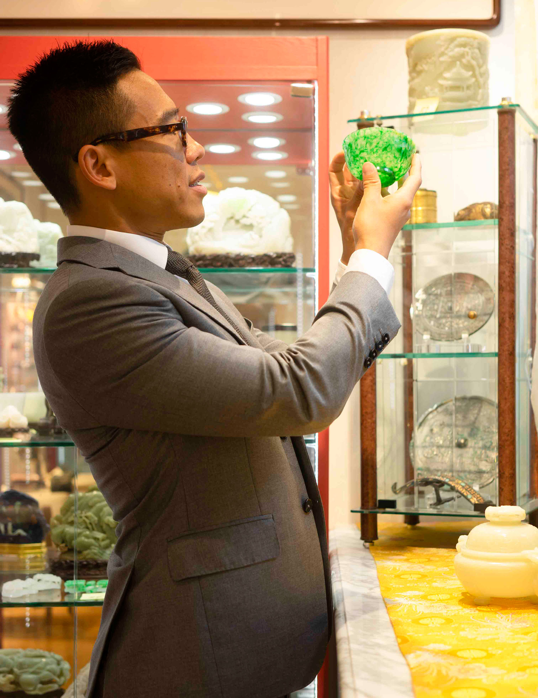 Ruben Lien with pieces from the jade collection of Mr Robert Chang, to be exhibited at Christie’s Hong Kong in 2020. Photograph by Jingya Liu