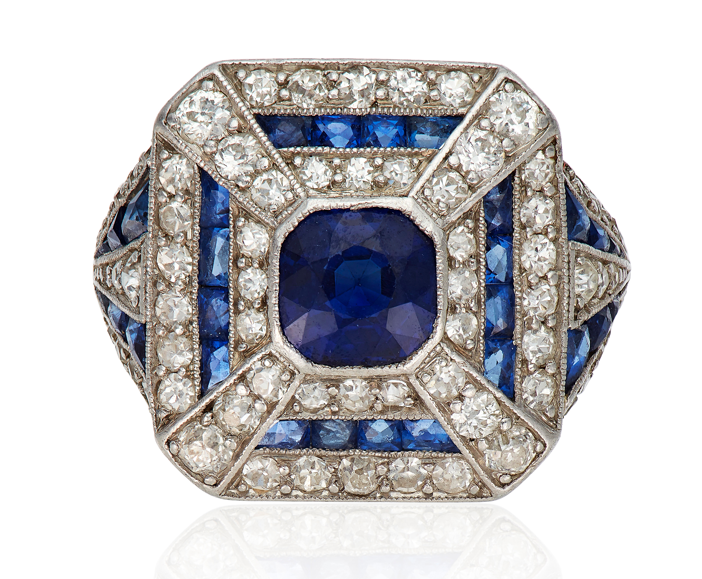 Art Deco sapphire and diamond ring. Set with a cushion-cut sapphire, within an old and single-cut diamond and calibre-cut sapphire surround. Sold for $6,875 on 12 Feb 2020, Online