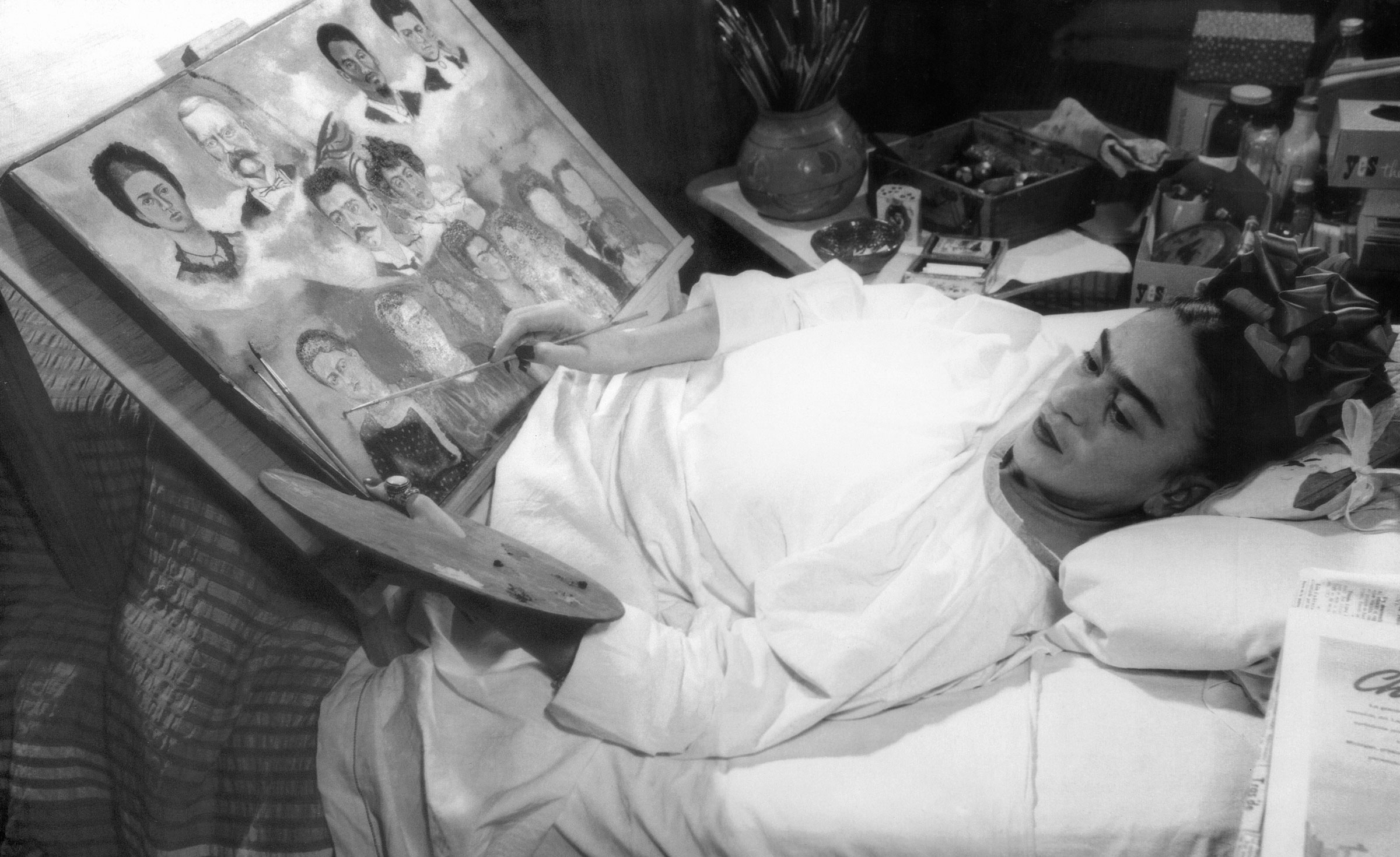 Frida Kahlo painting in bed, 1952. Photo: Granger / Bridgeman Images. Artwork: © Banco de México Diego Rivera Frida Kahlo Museums Trust, Mexico, D.F. / DACS 2020