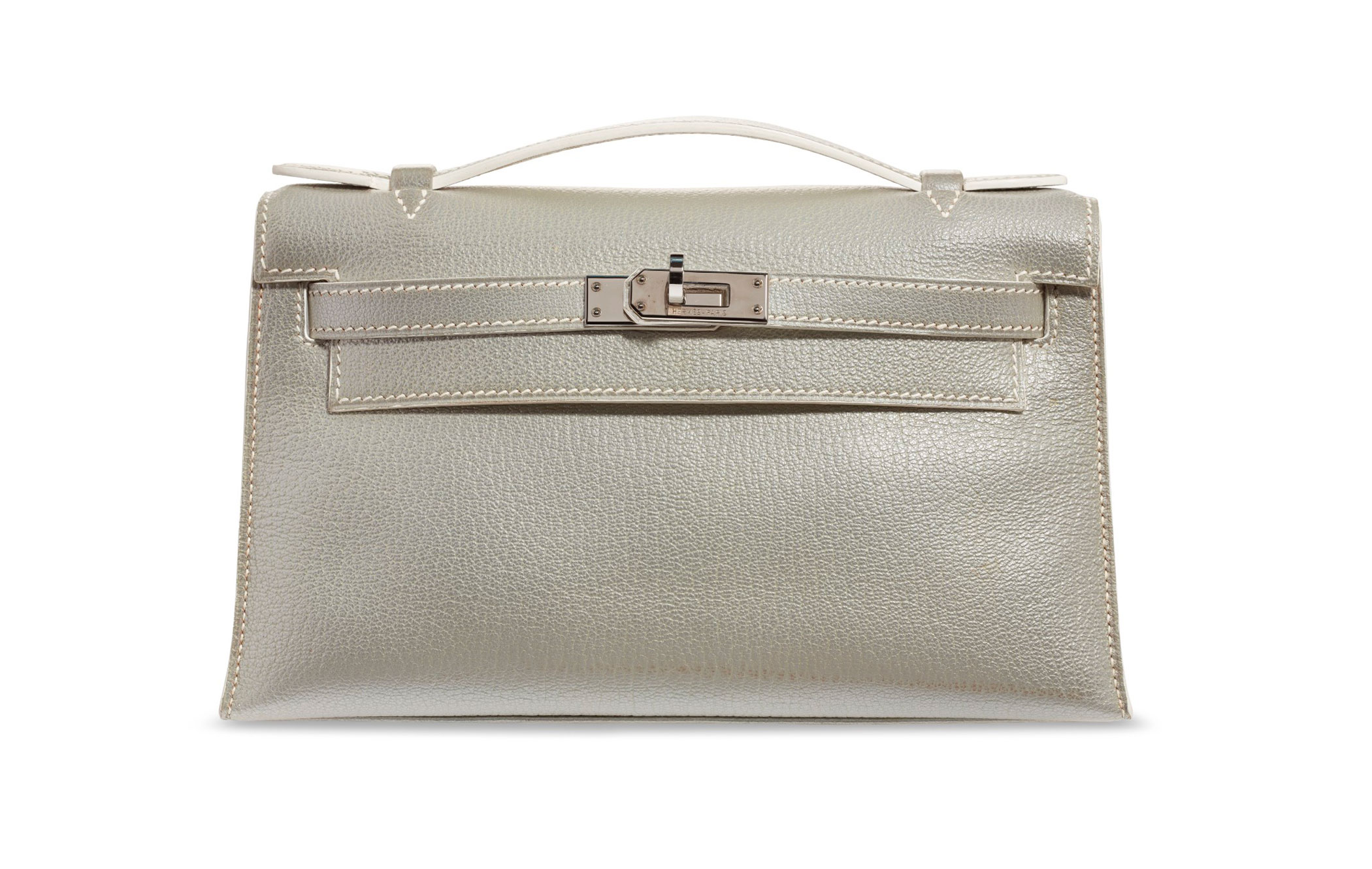 A rare, metallic silver chèvre leather Kelly pochette with palladium hardware, Hermès, 2005, from the collection of Susan Casden. 22 w x 13 h x 6 d cm. Sold for $20,000 in Handbags & Accessories Online: The New York Edition, 24 November-10 December 2020, Online