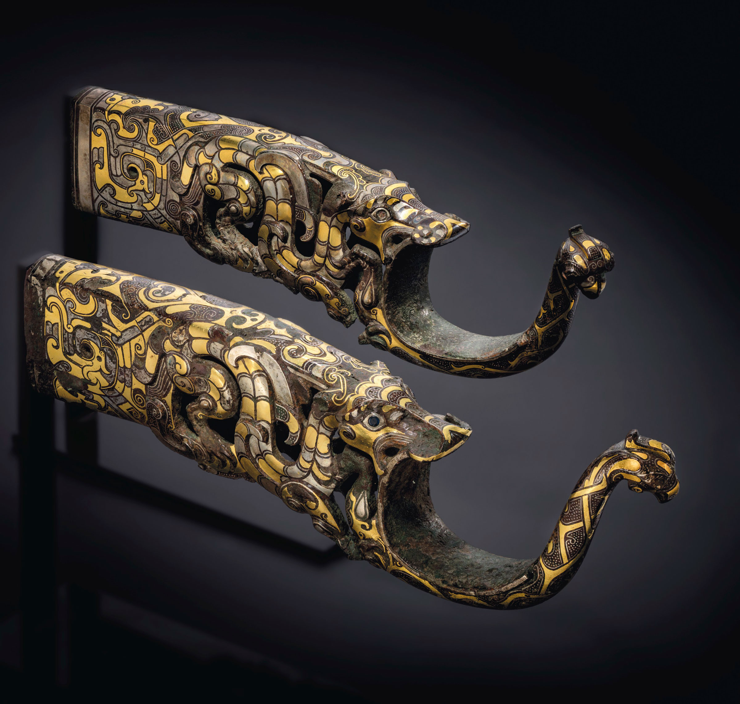 A rare and magnificent pair of gold and silver-inlaid bronze chariot fittings, Eastern Zhou dynasty, 4th-3rd century BC. 10¼ in (26 cm) long. Sold for £1,522,500 on 3 November 2020 at Christie’s in London