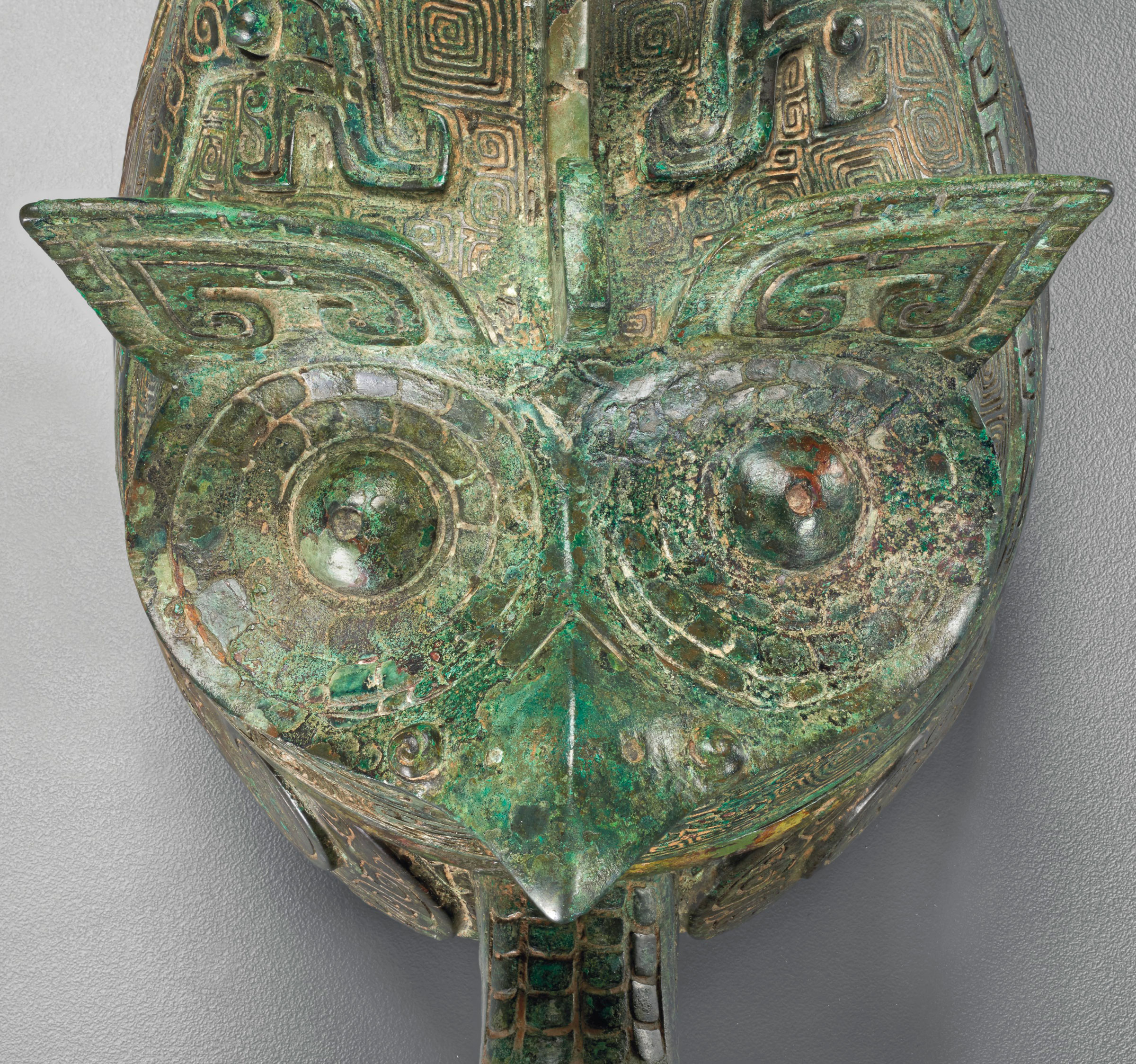 The owl and tiger forms that decorate the back and front of the gong