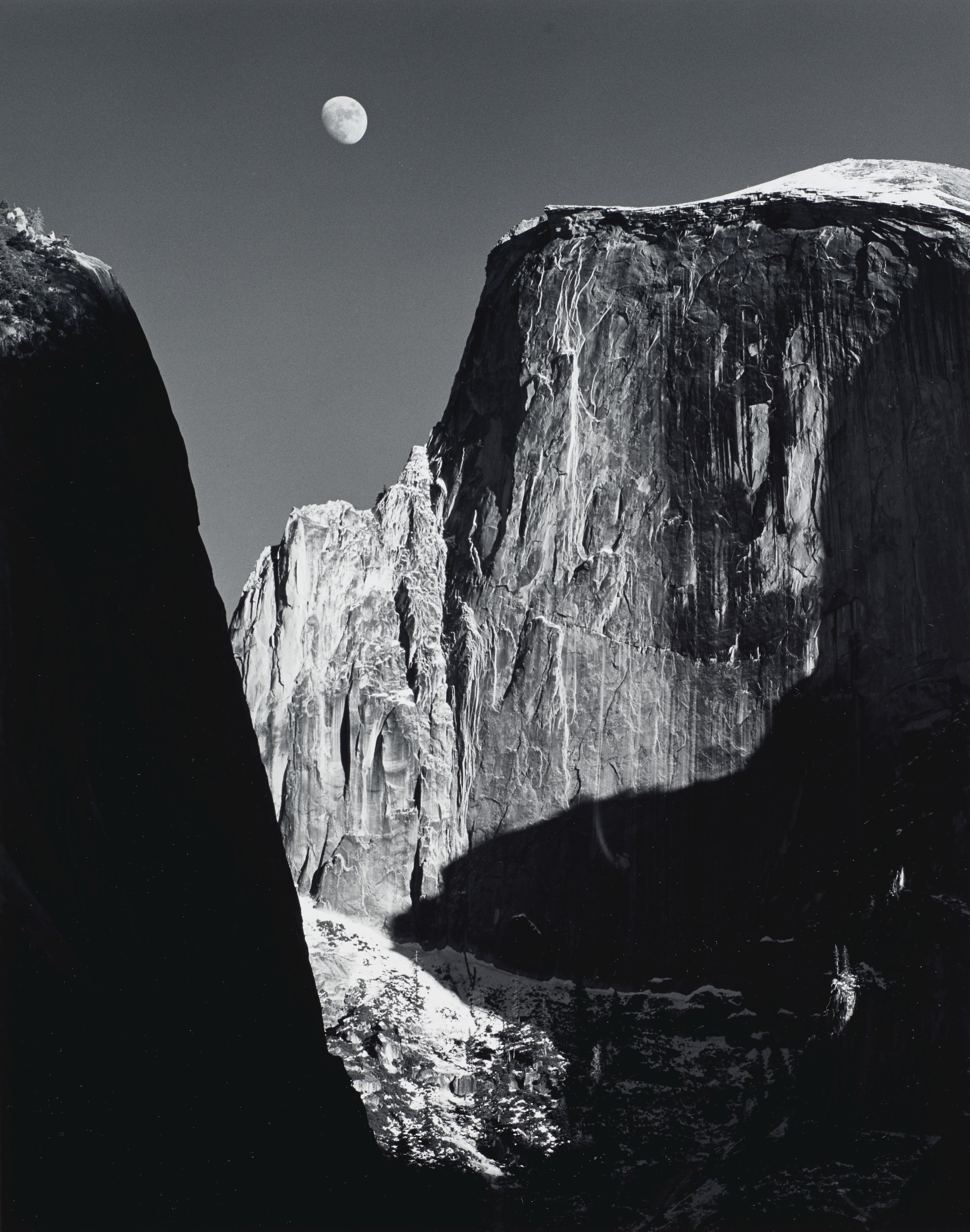 Ansel Adams (1902-1984), Moon and Half Dome, Yosemite National Park, California, 1960. Gelatin silver print, mounted on board, printed 1962. Image/sheet: 13&frac14; x 10&frac12;  in (33.6 x 26.6 cm); mount: 18 x 14 in (45.7 x 35.5 cm). Estimate: $30,000-50,000. Offered in Ansel Adams and the American West, 25 March-8 April, Online