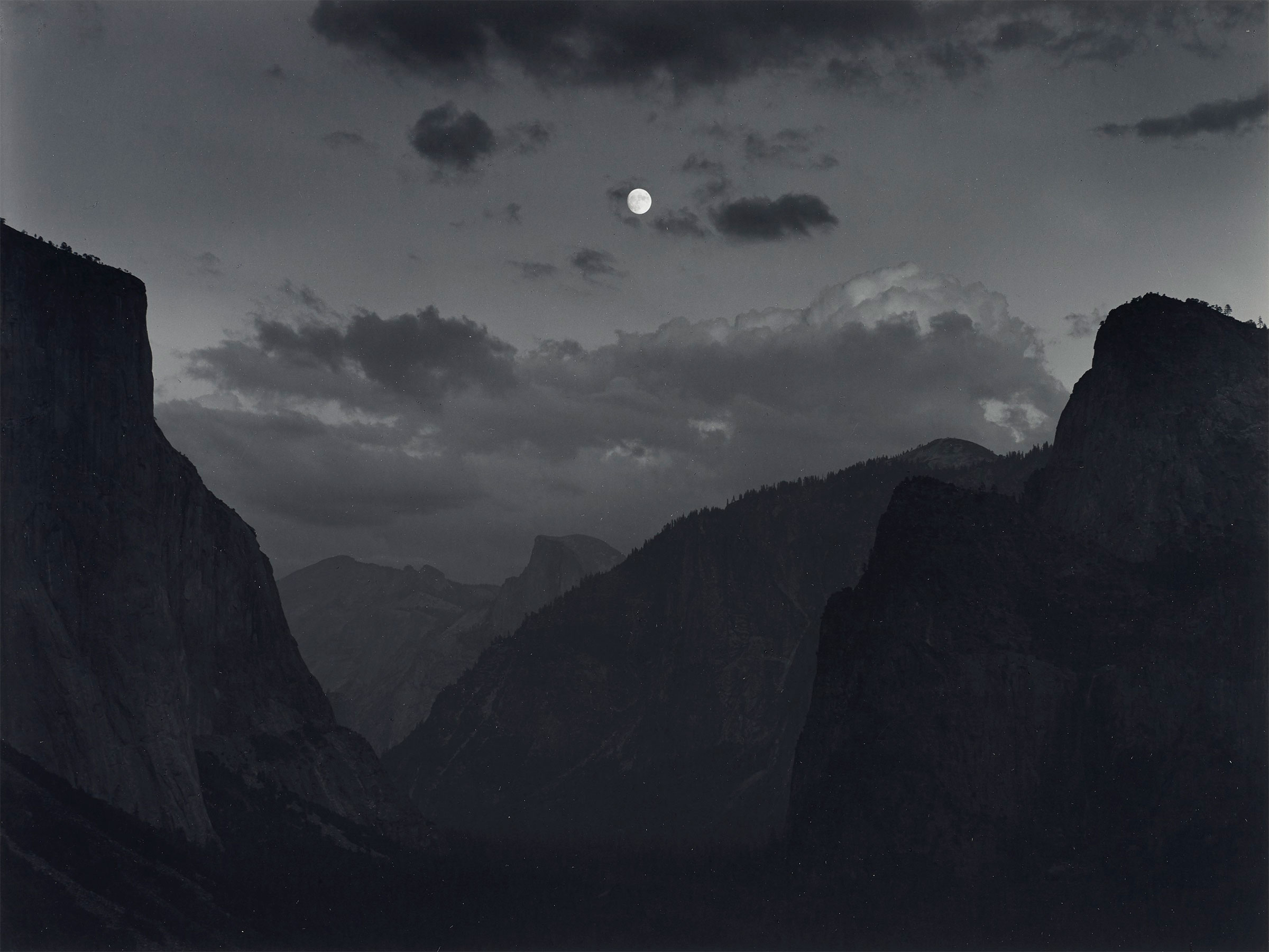 Ansel Adams (1902&ndash;1984), Yosemite Valley, Moonrise, Yosemite National Park, California, c. 1935. Gelatin silver print, mounted on board, printed 1973-1977. Image/sheet: 10 x 13⅜ in (25.4 x 33.9 cm); mount: 16 x 20 in (20.6 x 50.8 cm). Estimate: $8,000-10,000. Offered in  Ansel Adams and the American West, 25 March-8 April, Online
