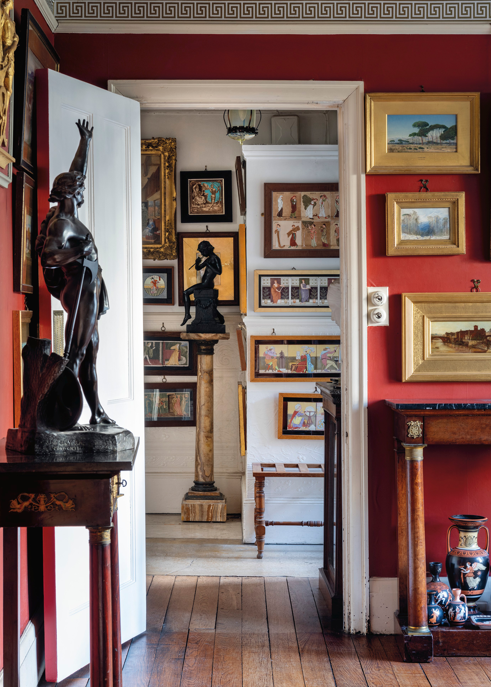 The inspiration for the red dining room room came from 19th-century travellers, explorers and archaeologists. The walls were filled with depictions of Italy and beyond by John William Inchbold, George Price Boyce and Edward Lear