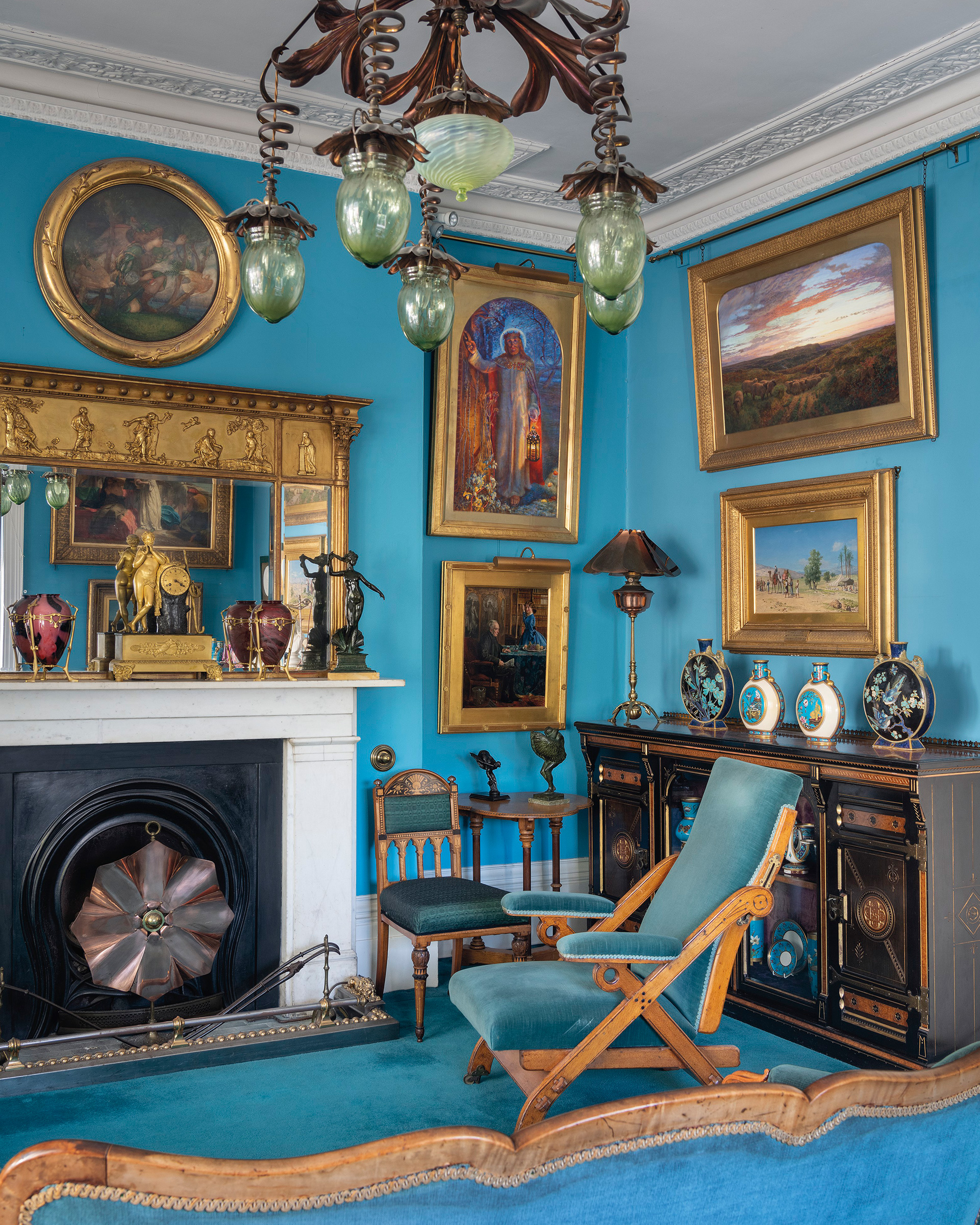 The blue drawing room, with Edward Robert Hughes&rsquo;s studio version of William Holman Hunt&rsquo;s masterpiece&nbsp;The Light of the World&nbsp;hanging to the right of the chimneypiece. The room&rsquo;s furnishings included reformed Gothic oak furniture and Minton porcelain alongside examples of the &lsquo;New Sculpture&rsquo; and avant-garde metalware by W.A.S. Benson