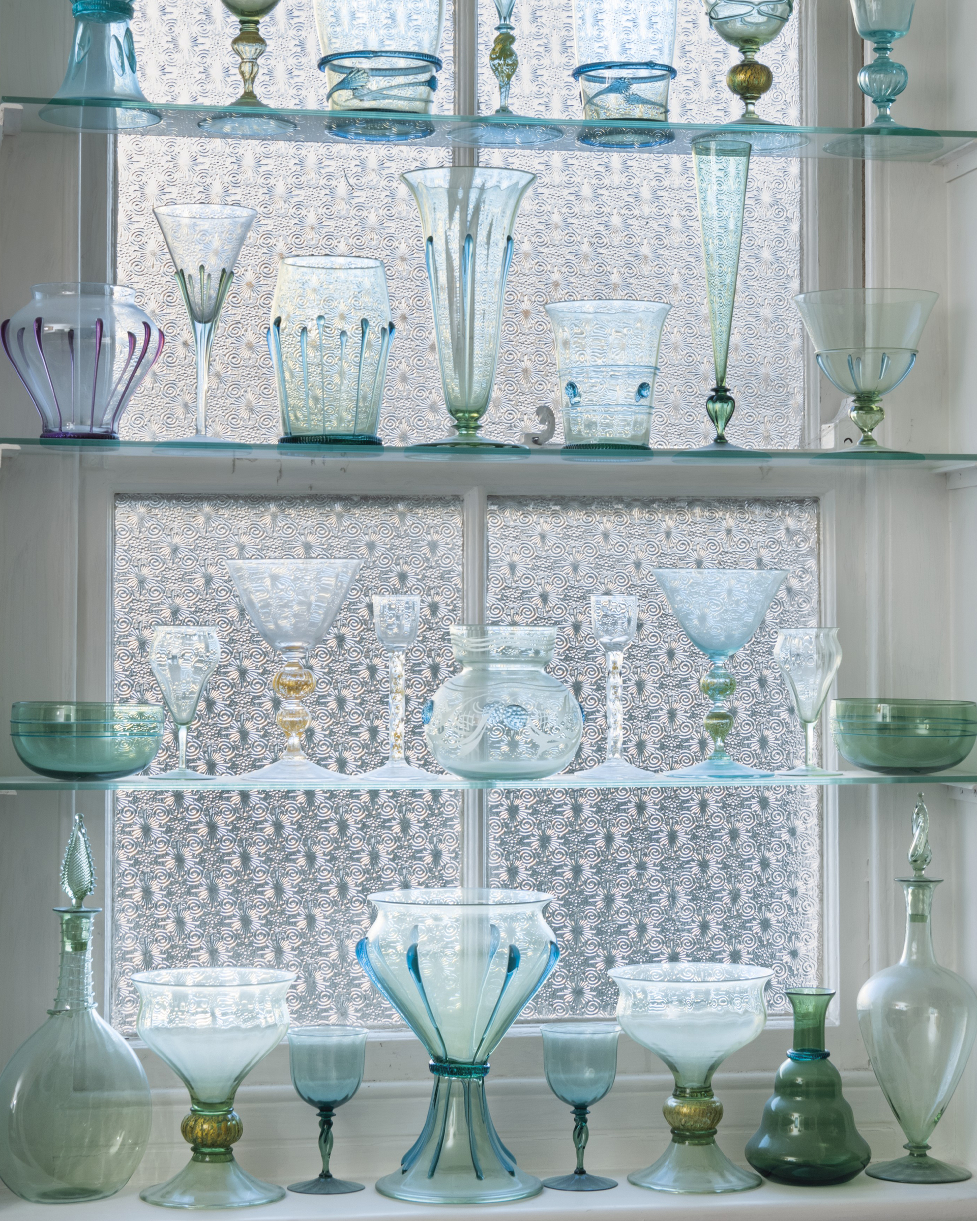 A collection of glass by James Powell &amp; Sons filled the window of the Whitefriars bathroom