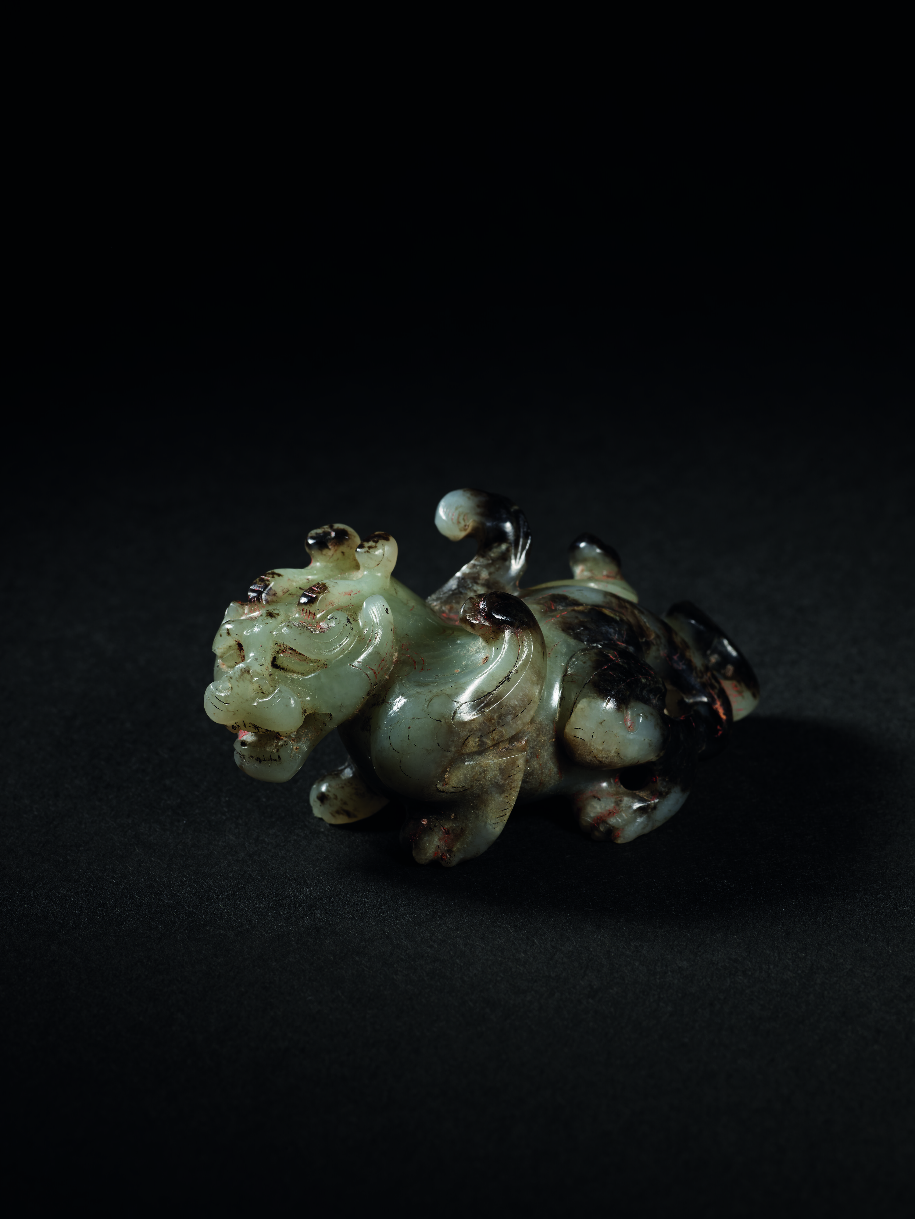 An exceedingly rare and exceptional jade carving of a mythical beast, bixie. Late Western Han Dynasty, c. 1st Century BC. 7.2 cm (2⅞ in) long, box. Sold for HK$26,850,000 in The Chang Wei-Hwa Collection of Archaic Jades Part IV: The Qin and Han Periods on 29 November 2022 at Christie’s in Hong Kong