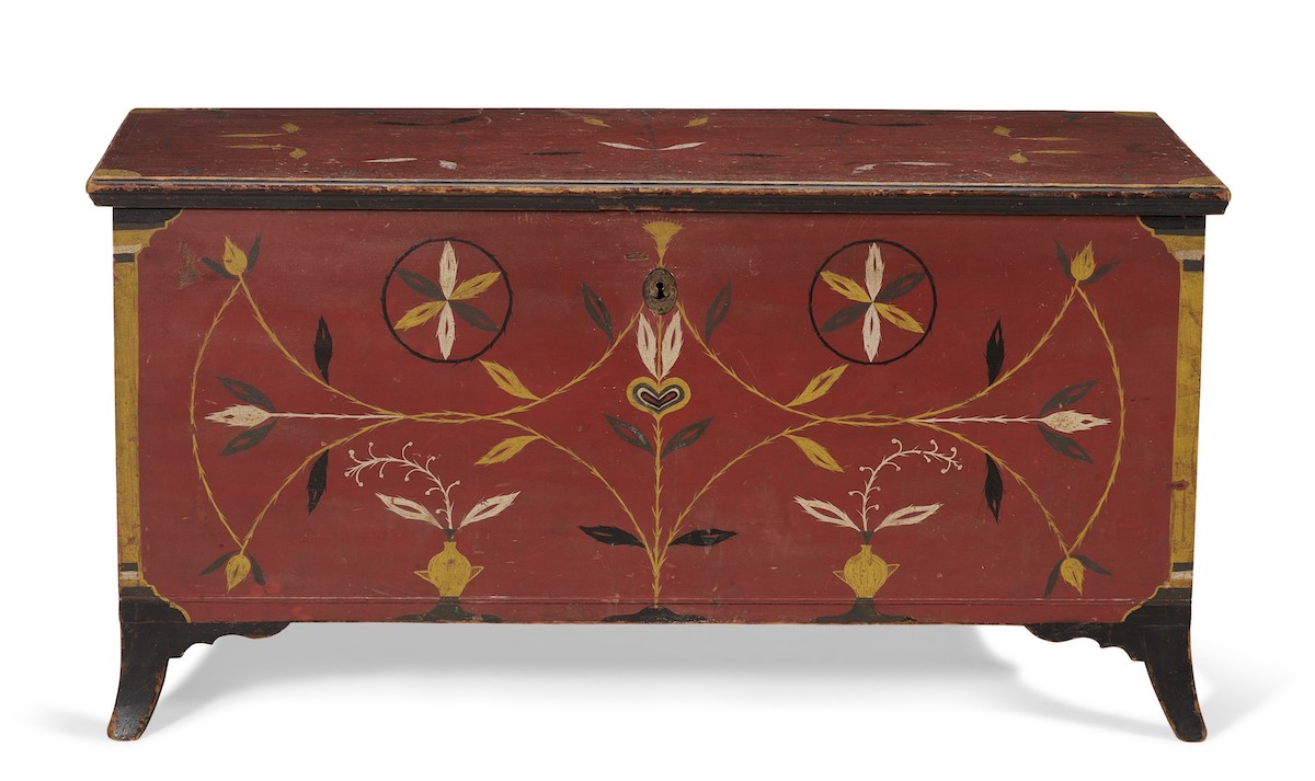 A federal red-painted and polychrome-decorated poplar blanket chest, Pennsylvania, 1815-1825. In shades of yellow, green, white and black on a red ground. 25½ in high, 49¾ in wide, 20¾ in deep (65 x 126.5 x 53cm). Estimate: $70,000-90,000. Offered in The Collection of Peter and Barbara Goodman on 20 January 2022 at Christie’s in New York