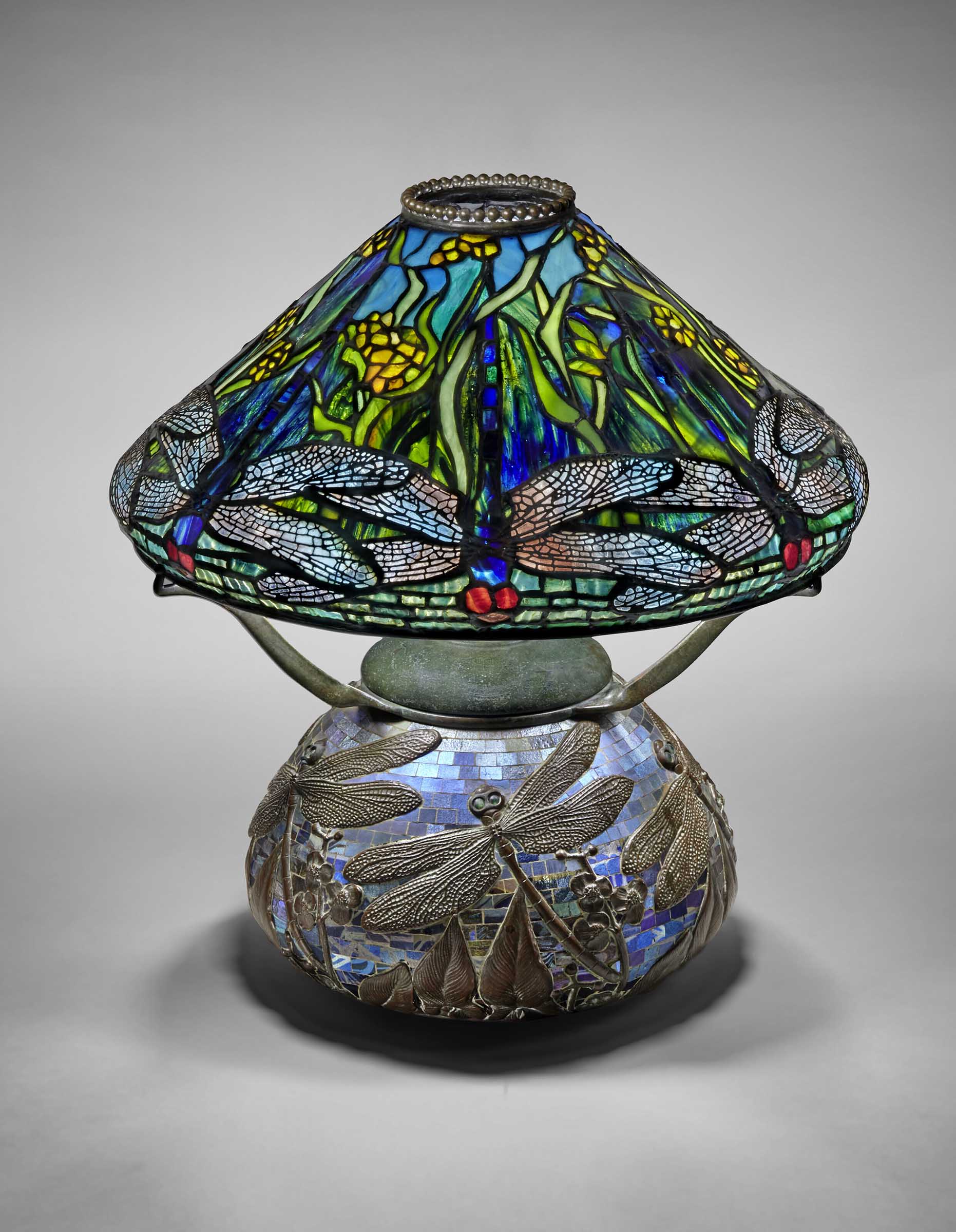 Tiffany Studios, Early and rare 'Dragonfly and Waterflowers' table lamp, c. 1900. Leaded glass, mosaic Favrile glass, patinated bronze. 17¾ in. (45.1 cm) high, 16 in. (40.6 cm) diameter of shade. Sold for $756,000 in Tiffany Masterworks from the Garden Museum: A Private Collection on 10 June 2022 at Christie's in New York