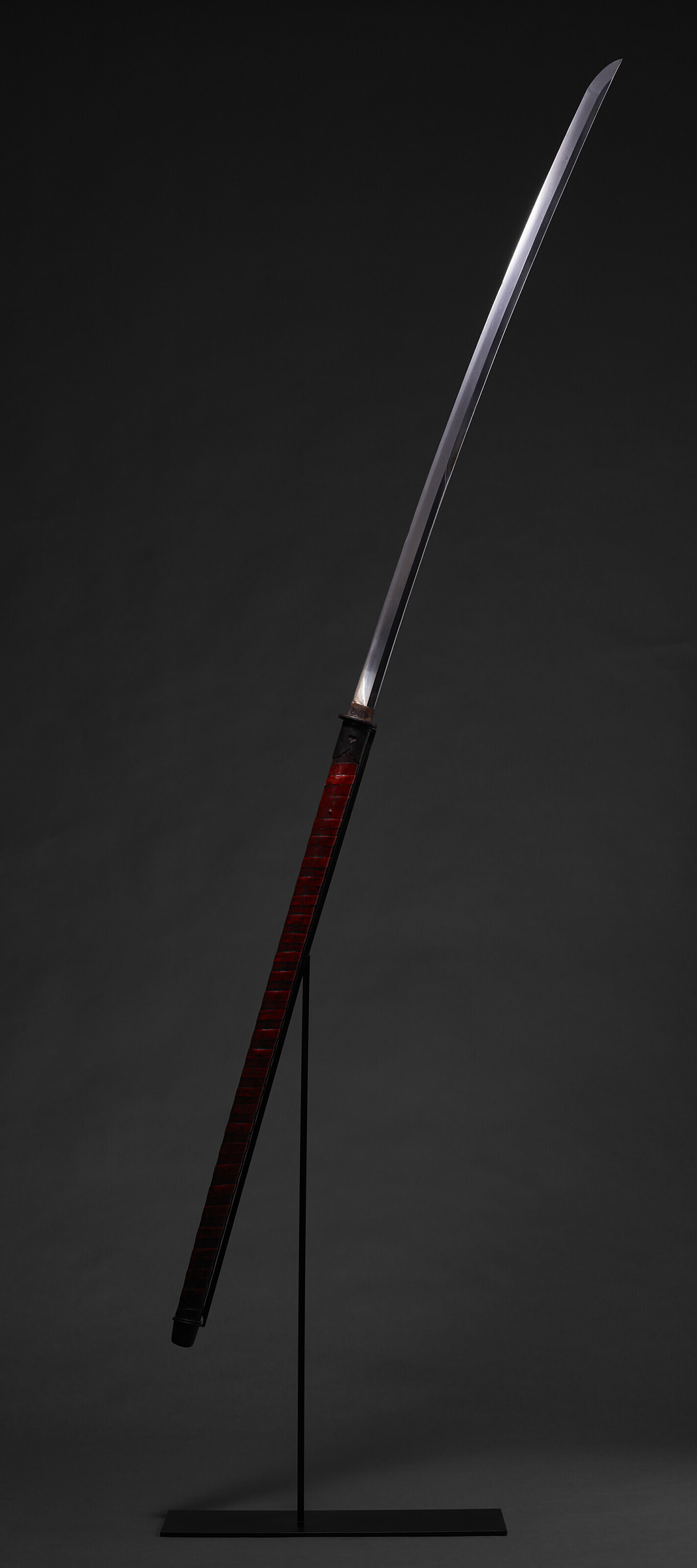 A nagamaki and a red lacquer scabbard, Muromachi period (mid-16th century). 84⅕ (215 cm). Estimate: $25,000-35,000. Offered in Japanese and Korean Art on 20 September 2022 at Christie's in New York