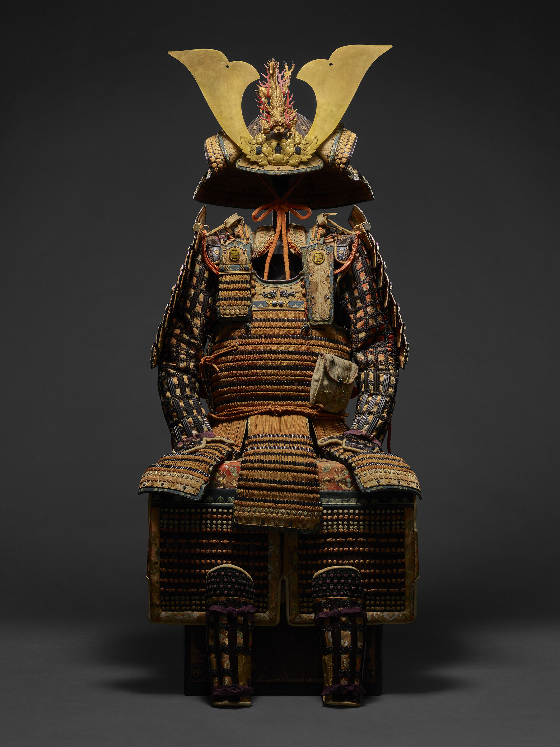 An orange honkozane daimyo domaru gusoku (armor), Edo period (18th century), Helmet bowl: Nanbokucho period (14th century). Estimate: $80,000-120,000. Offered in Japanese and Korean Art on 20 September 2022 at Christie's in New York