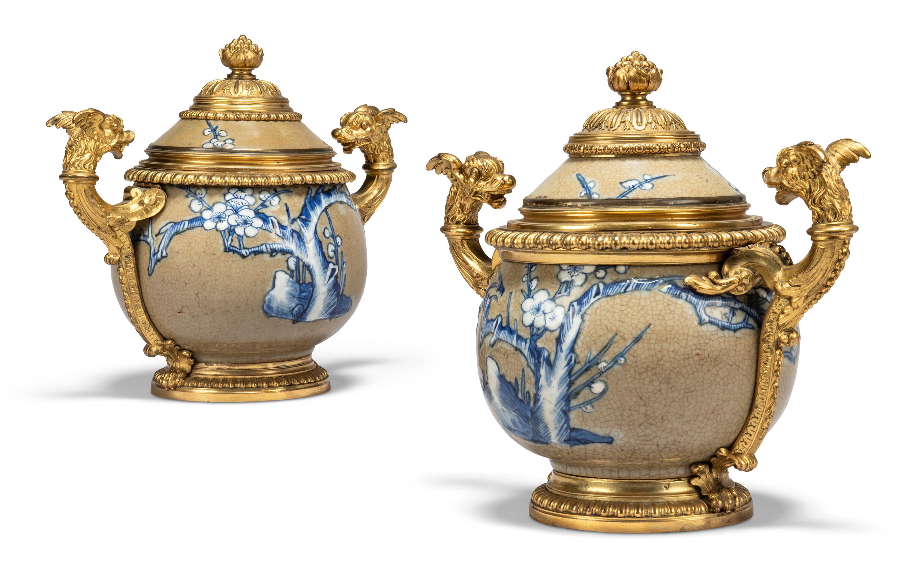 A near pair of Régence ormolu-mounted Chinese crackle-glazed vases and covers, circa 1725. The porcelain Kangxi (1662-1722). 11½ in (29 cm) high; 13½ in (34 cm) wide over handles.