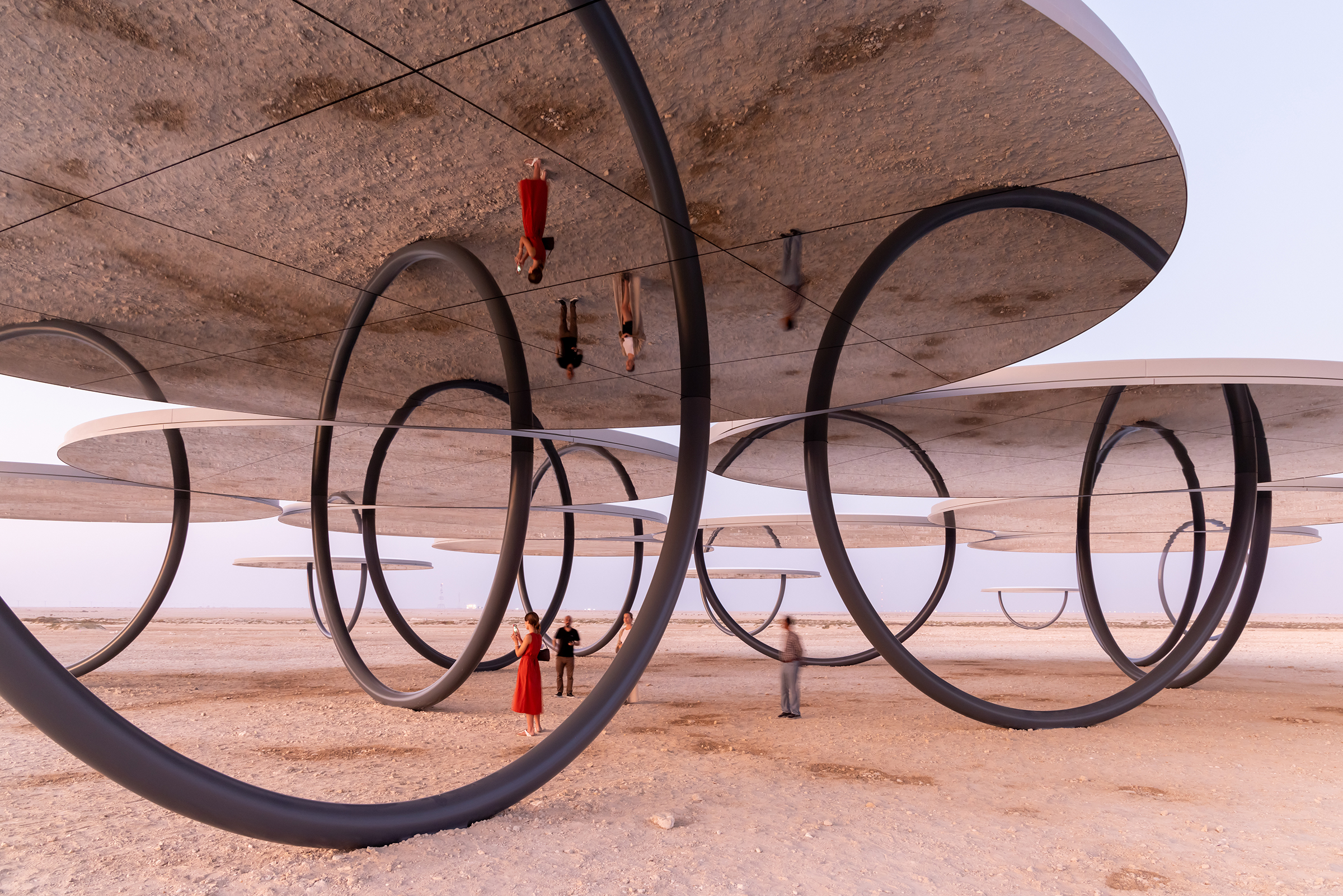 Olafur Eliasson (b. 1967), Shadows Travelling on the Sea of the Day, 2022. Painted steel, fibreglass, chromium silvered glass mirrors. Total site: 163.5 x 125.7 metres; 20 pavilions (each: height 4.5 metres, diameter 10.35 metres), three single. Installation view, Al Zubarah. Photo: © Iwan Baan. Courtesy of the artist; neugerriemschneider, Berlin; Tanya Bonakdar Gallery, New York / Los Angeles. © 2022 Olafur Eliasson