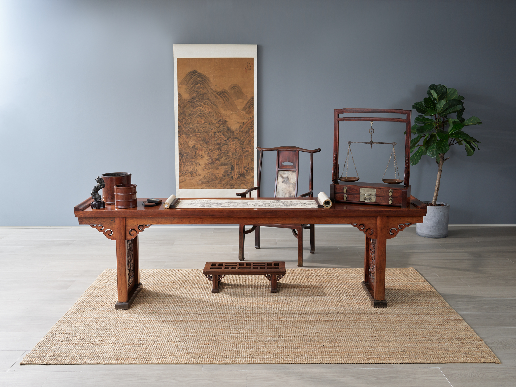 A very rare and large stone-inset huanghuali yokeback armchair, sichutou guanmaoyi. Ming dynasty, 16th-17th century. 45 ¼ in (115 cm) high. Sold for HK$11,250,000.
A magnificent large huanghuali recessed trestle-leg table, qiaotou’an, 17th century. 108 ⅛ in (274.5 cm) wide. Sold for HK$34,050,000. A rare large huanghuali balance stand, tianpingjia, 17th century. 30¼ in (77 cm) high. Sold for HK$2,142,000. A very rare huanghuali recessed-leg footstool, jiaota. Ming dynasty, 16th-17th century. 28 in (71 cm) wide. Sold for HK$1,071,000. All sold in Rich Golden Hues And Graceful Forms - Classical Chinese Furniture From The Tseng Collection on 29 November 2022 at Christie’s in Hong Kong